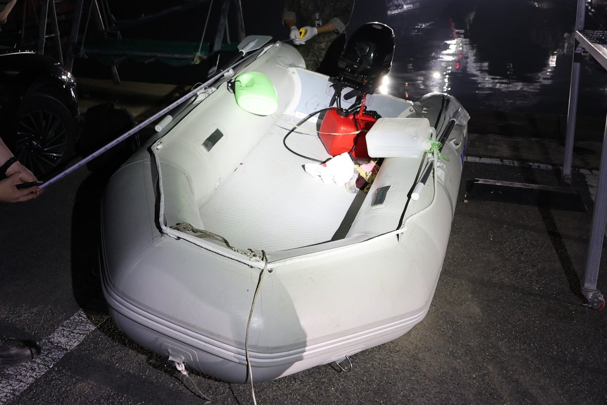 A Chinese dissident is in South Korean custody after a perilous escape by rubber boat