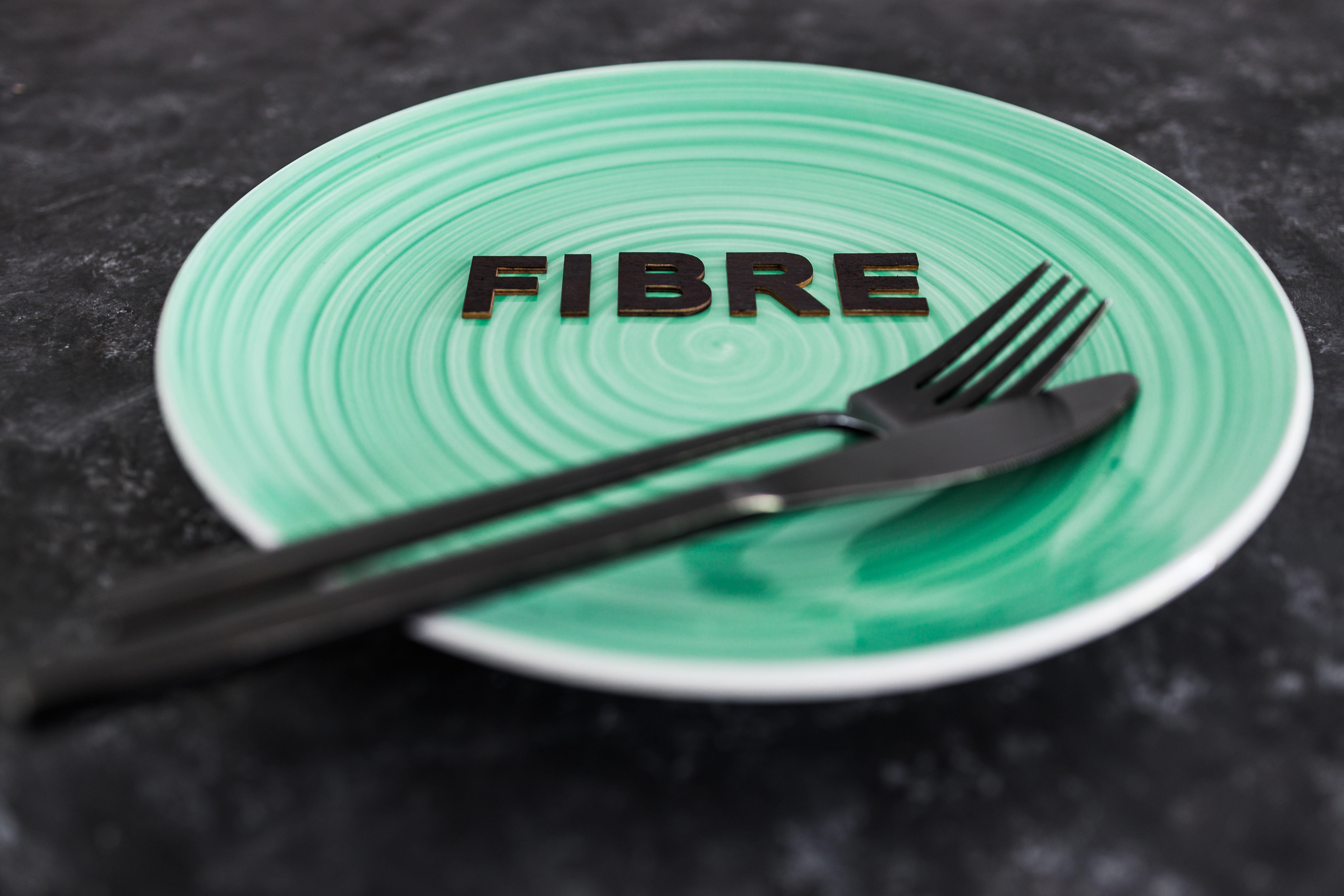 Fibre text on dining plate with fork and knife (Alamy/PA)