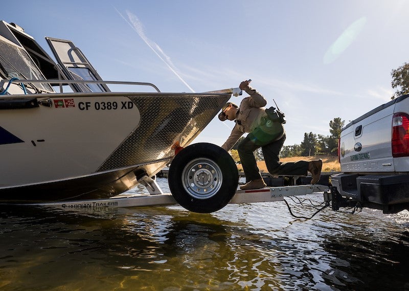 A official inspects the hull of a boat for golden mussels in California in this April 2025 image from the state’s Department of Fish and Wildlife