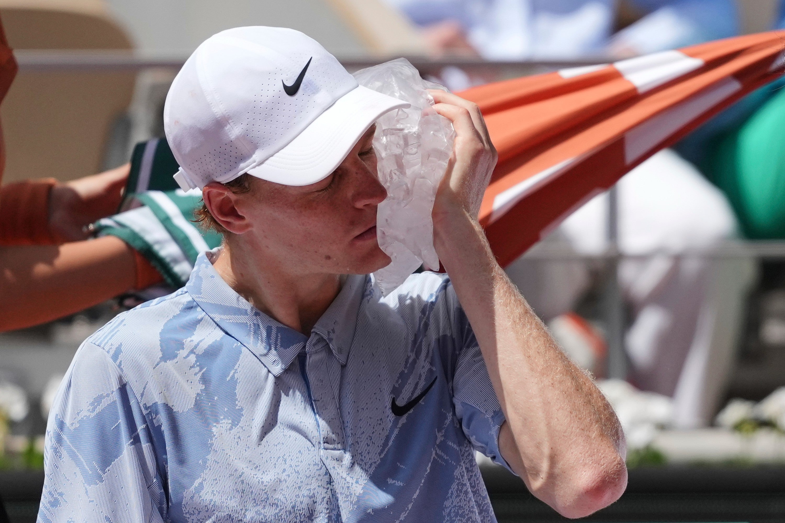 Jannik Sinner applies ice to his face (Thibault Camus/AP) (AP)