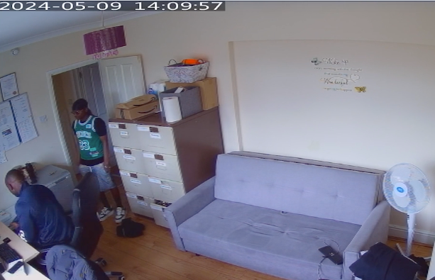 A CCTV grab shows Rahman being handed a knife from the set kept in the supported accommodation office.