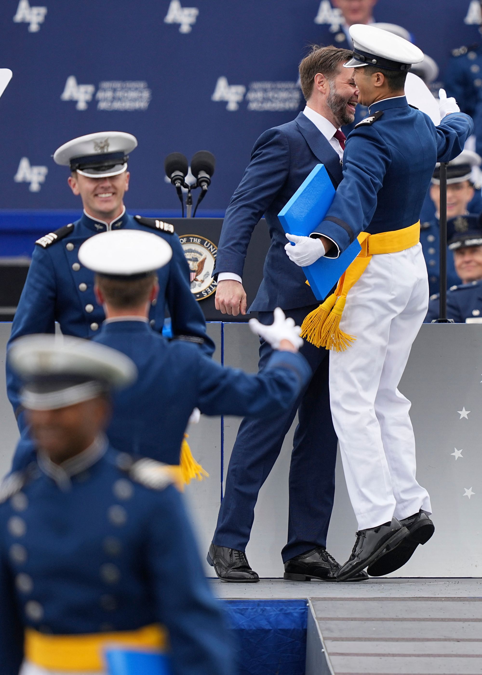 US Vice President JD Vance gives a chest bump to a graduating cadet during the 2026 graduation ceremony at the US Air Force Academy in Colorado Springs