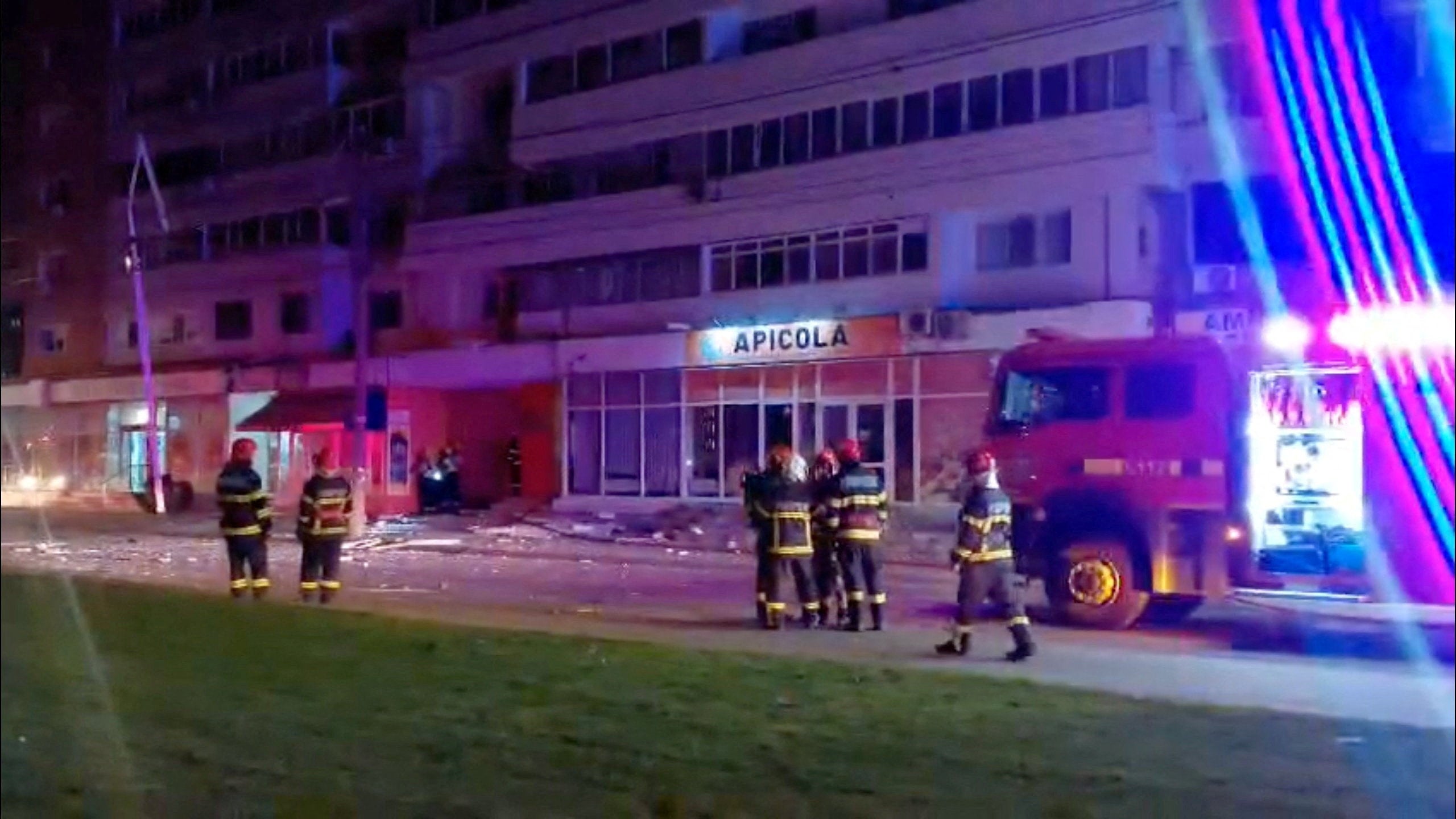 Firefighters work near a building, which, according to a Facebook post by Romanian radio station Pro Lider FM, was hit by a drone, close to the border with Ukraine, in Galati, Romania