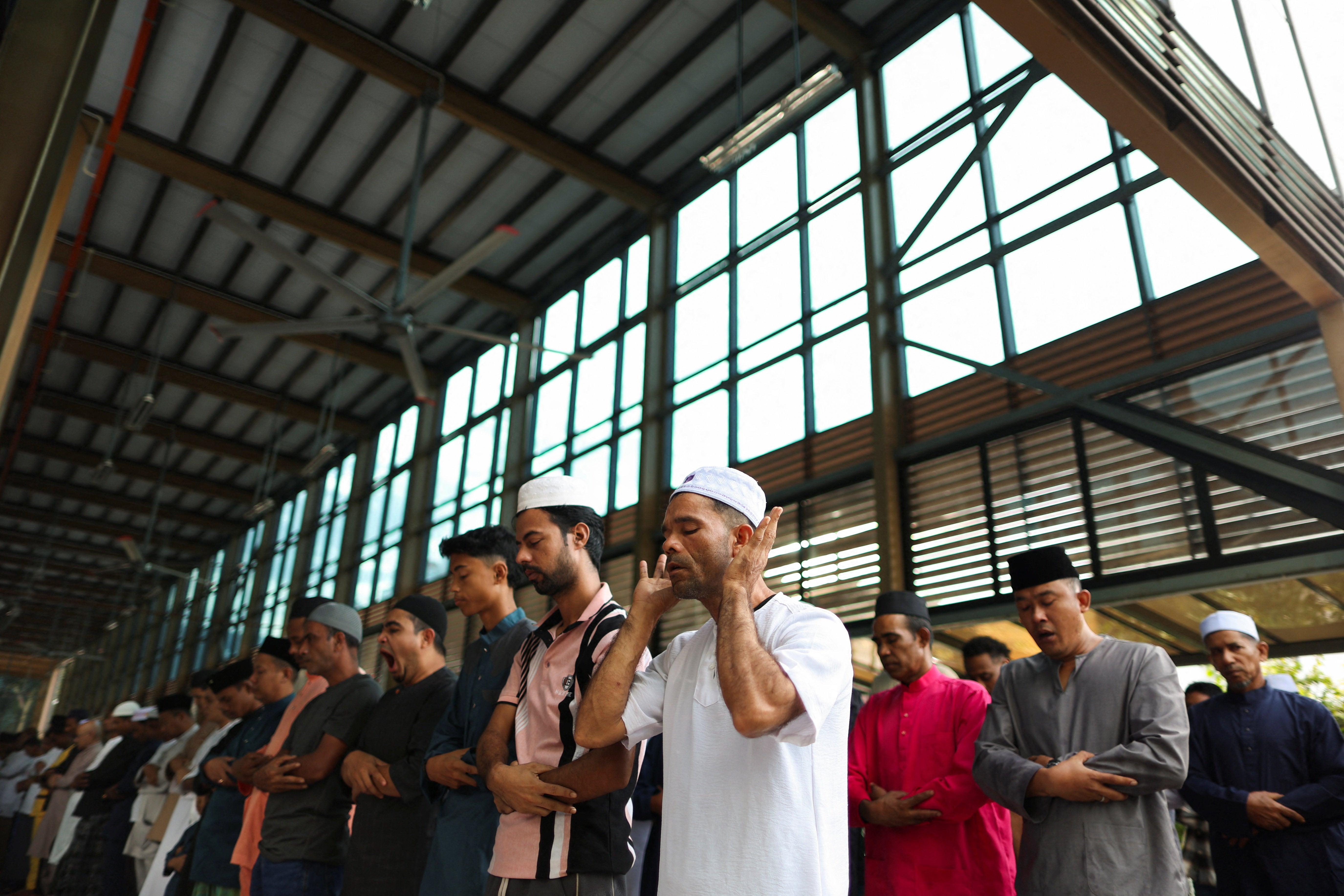 Muslims perform Eid al-Adha mass prayers at a mosque in Ampang, Malaysia (Reuters)