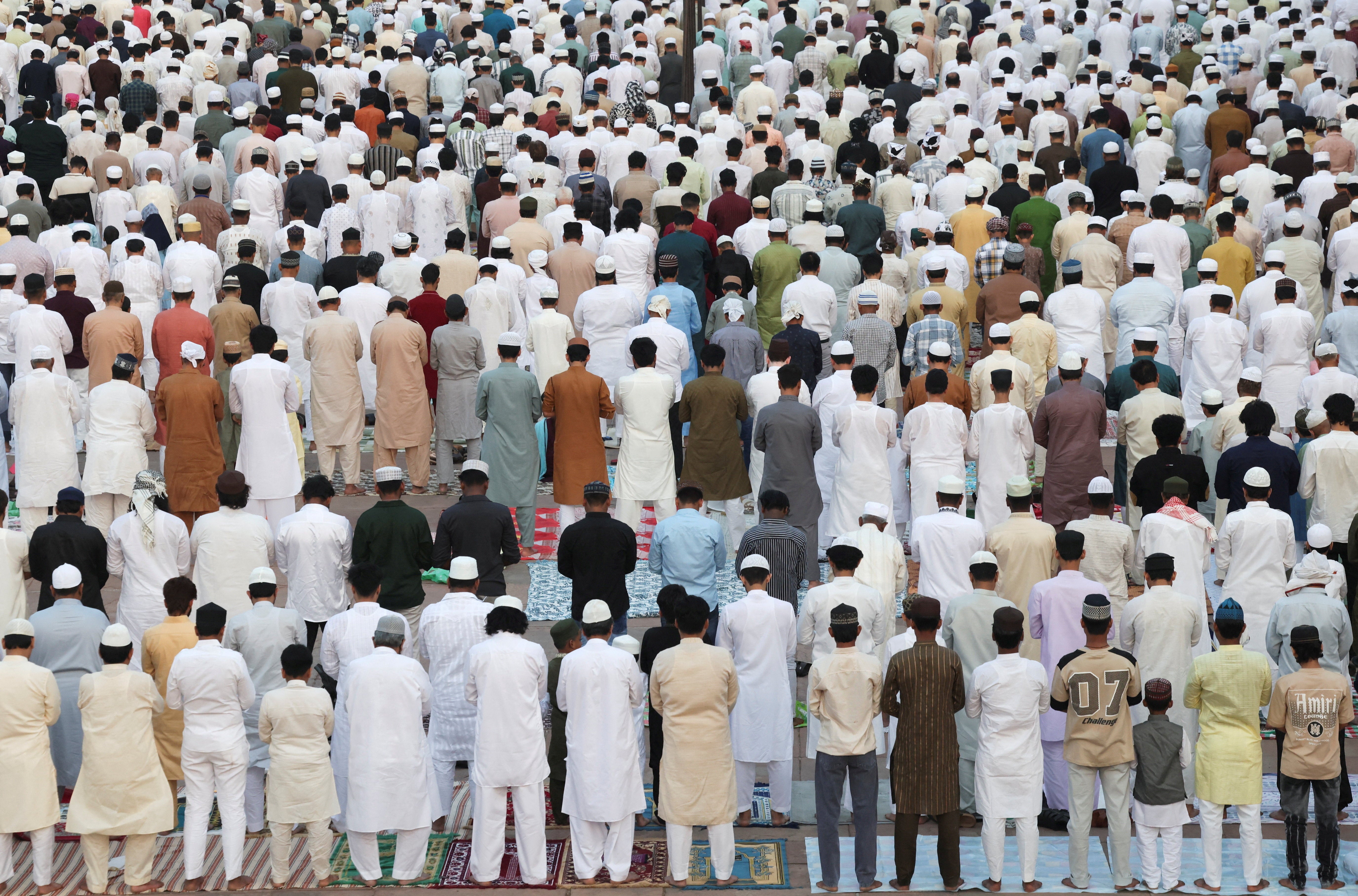 Muslims gather to offer prayers on the occasion of Eid al-Adha at Jama Masjid, in the old quarter of Delhi, India