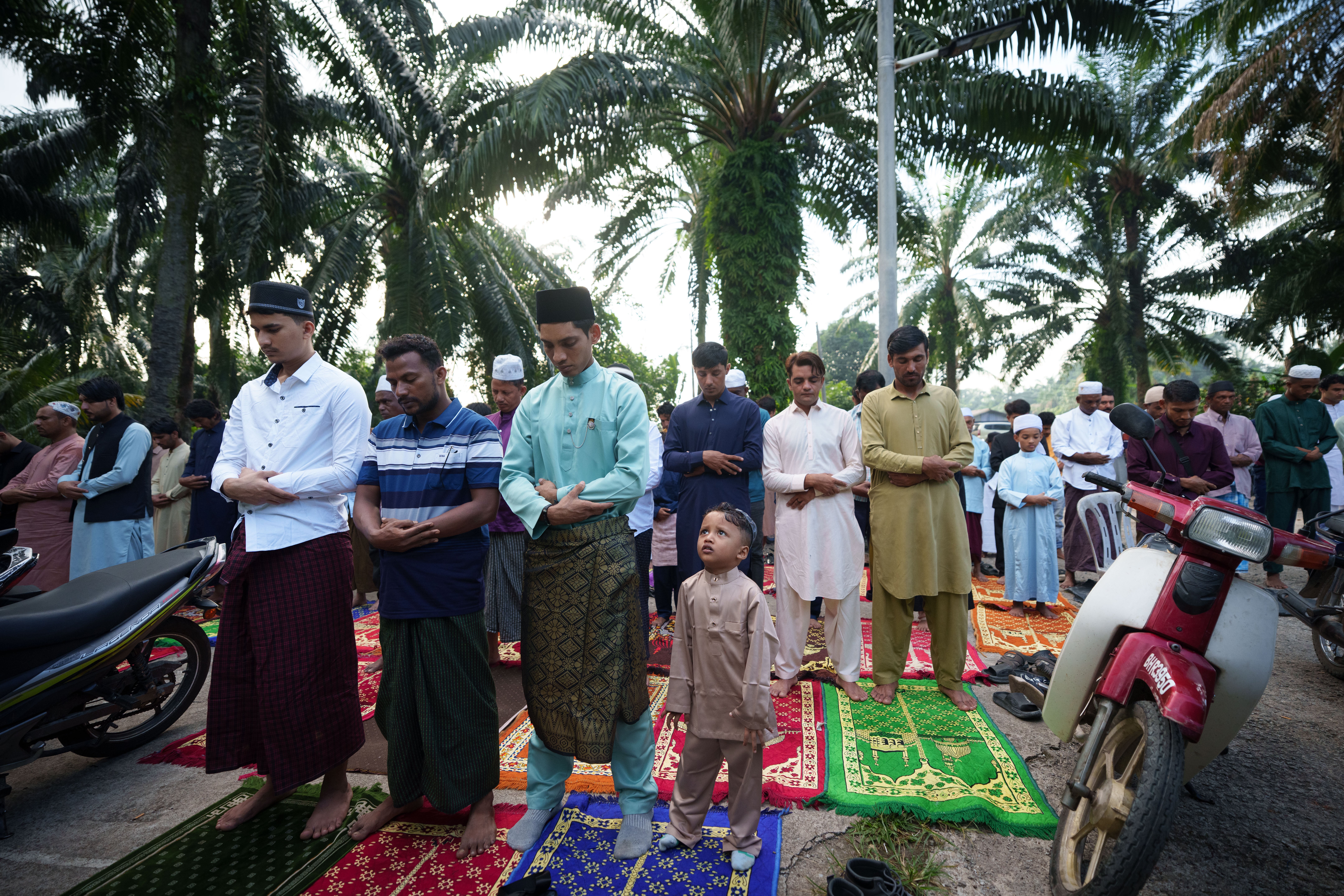 Rohingya muslims perform morning prayer marking Eid al-Adha outside a mosque in Klang, outskirt of Kuala Lumpur, Malaysia (AP)