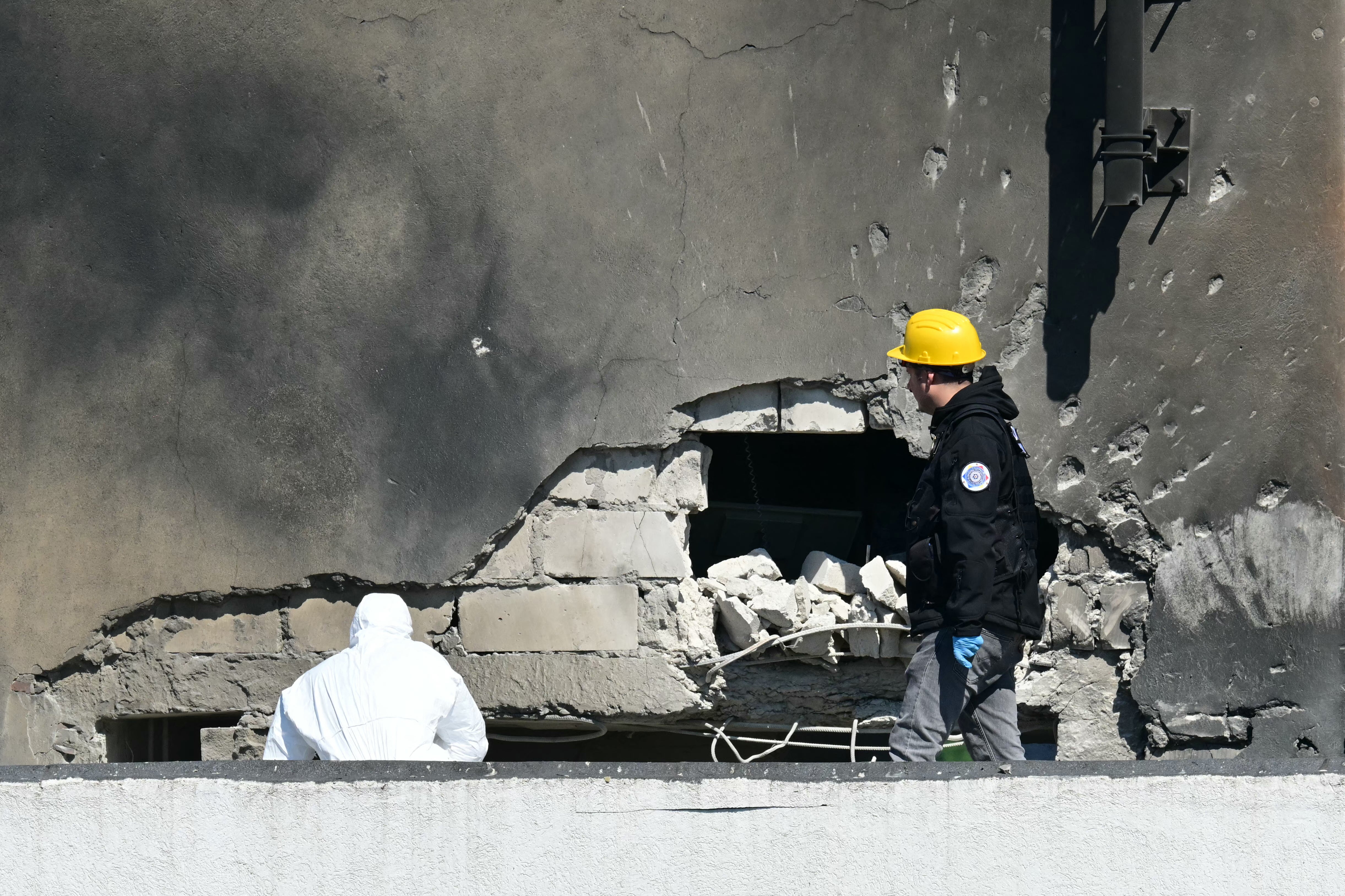 Police and forensic investigators examine the location of impact after a Russian drone struck an apartment building in Galati (AFP/Getty)