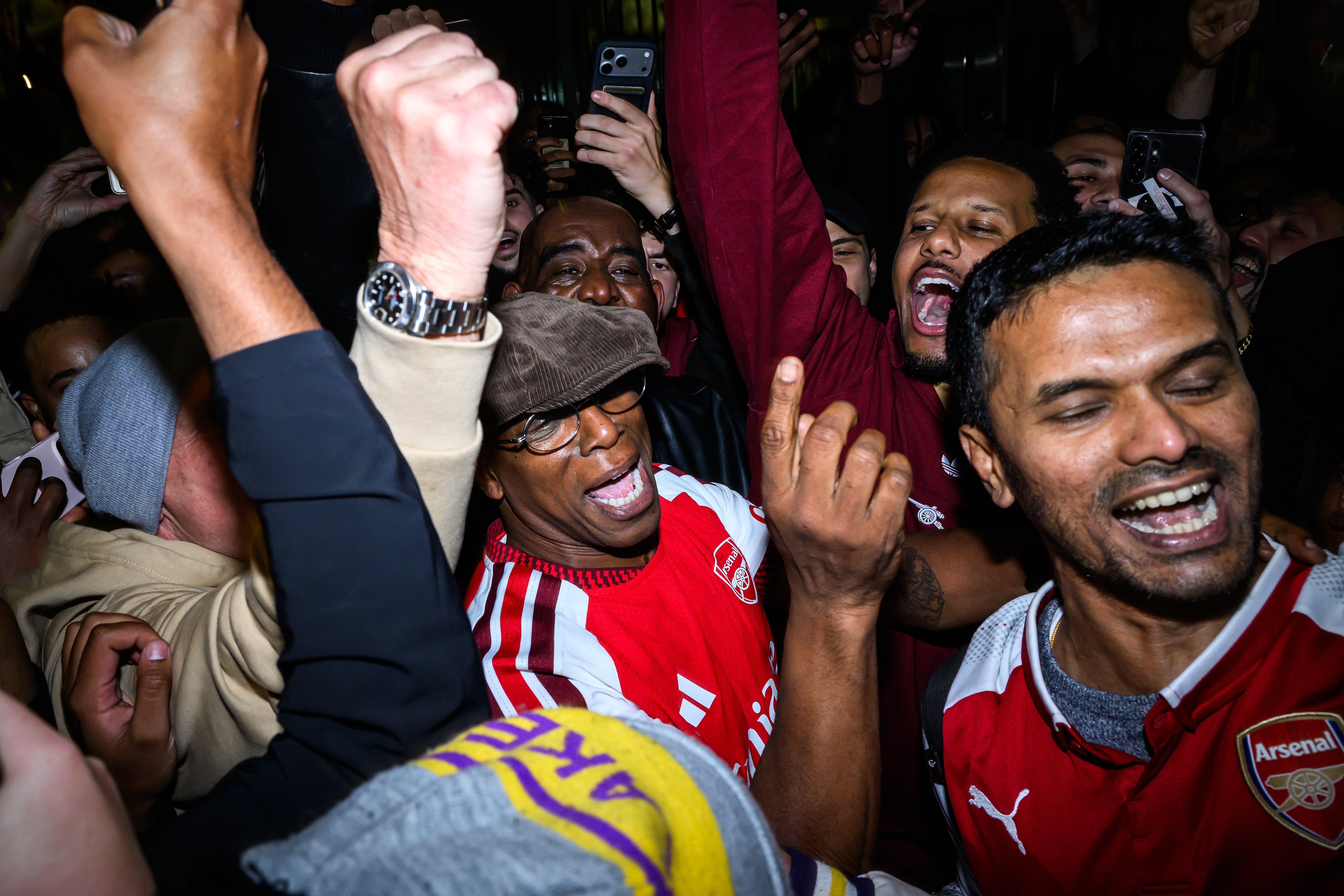 Ian Wright celebrates with supporters at Emirates Stadium as Arsenal take the Premier League title