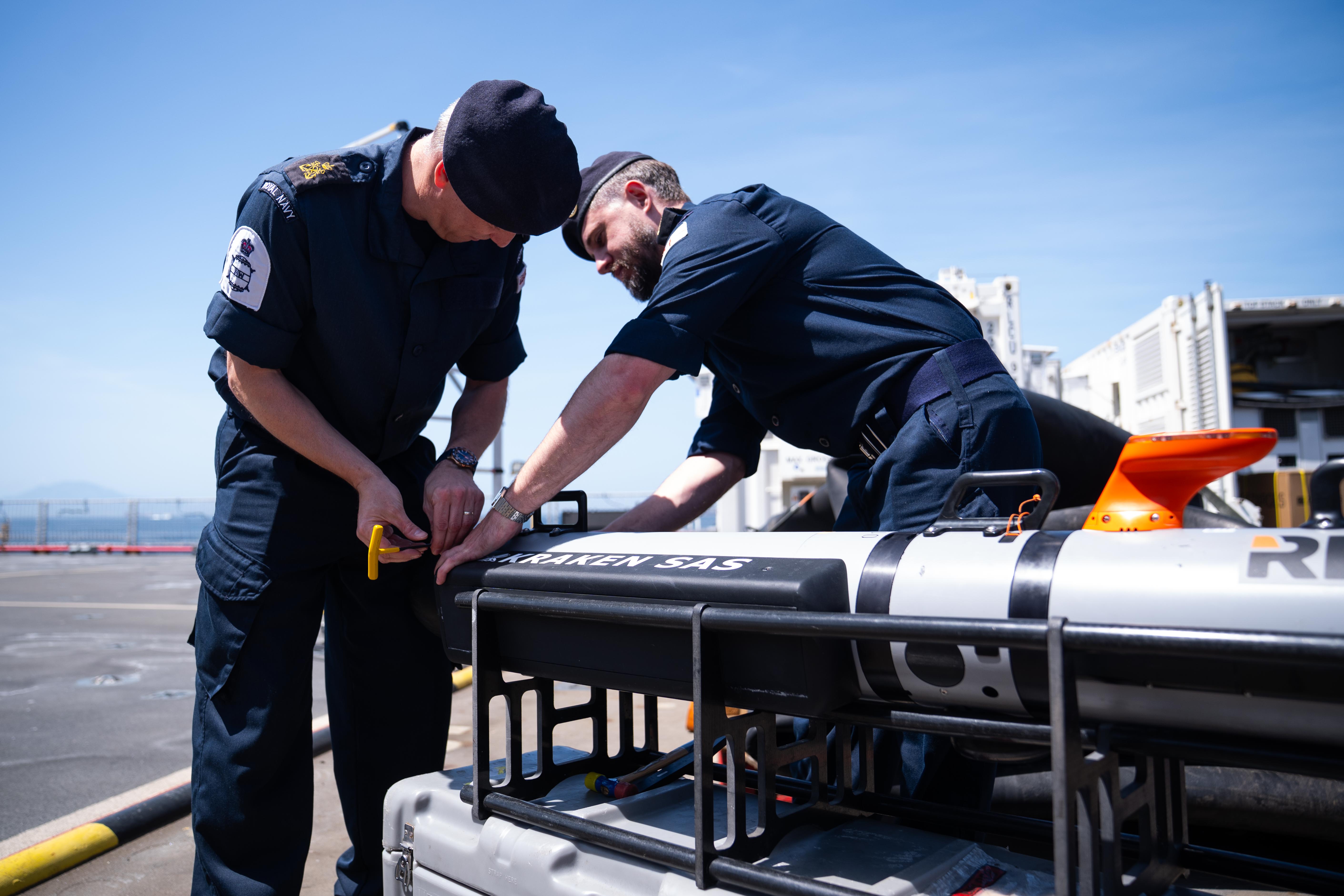 Members of the Royal Navy work on mine hunting equipment on the RFA Lyme Bay in Gibraltar, May 2026