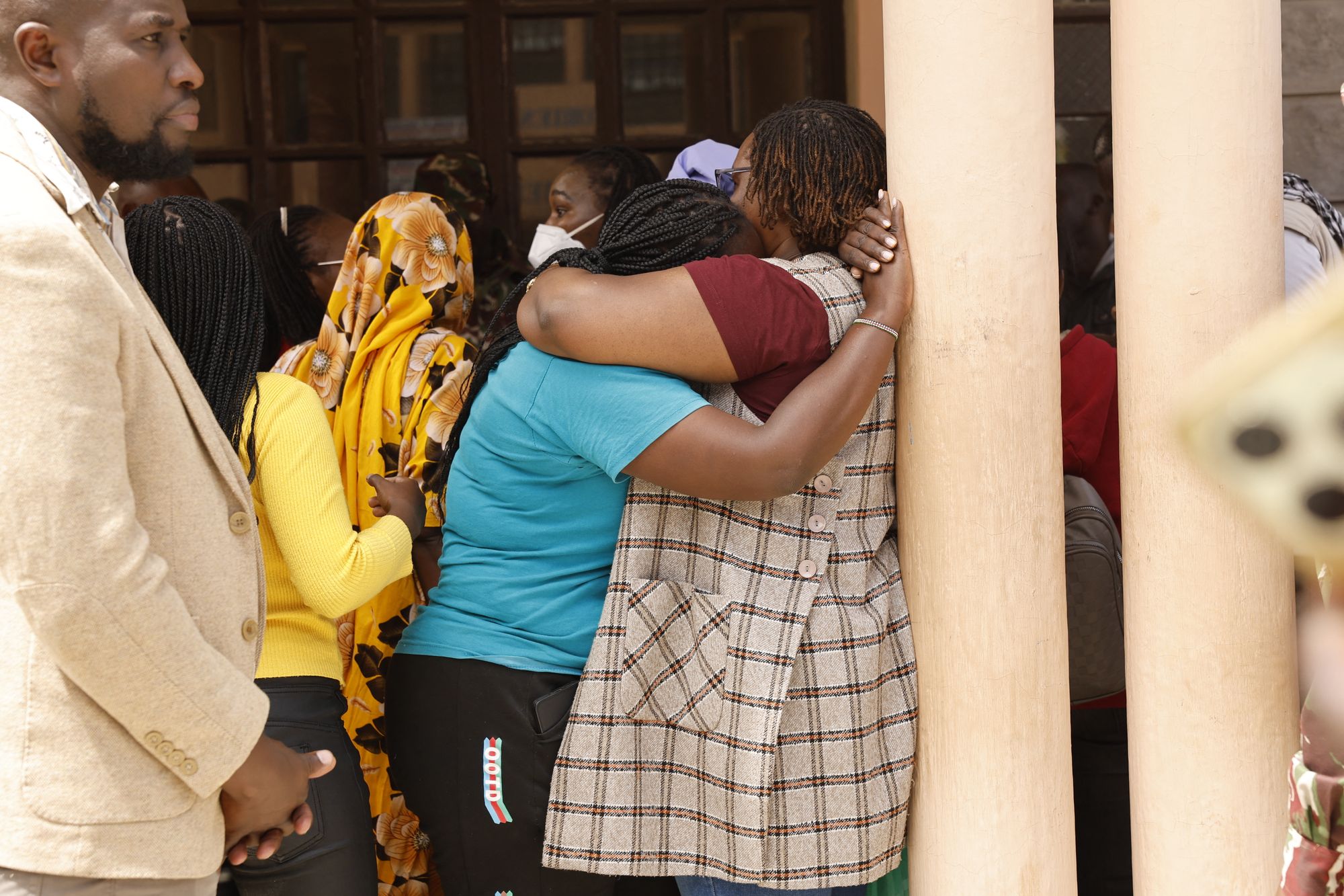 Relatives comfort each other at Utumishi Girls Academy following the deadly fire in Gilgil, north of the capital Nairobi on May 28, 2026