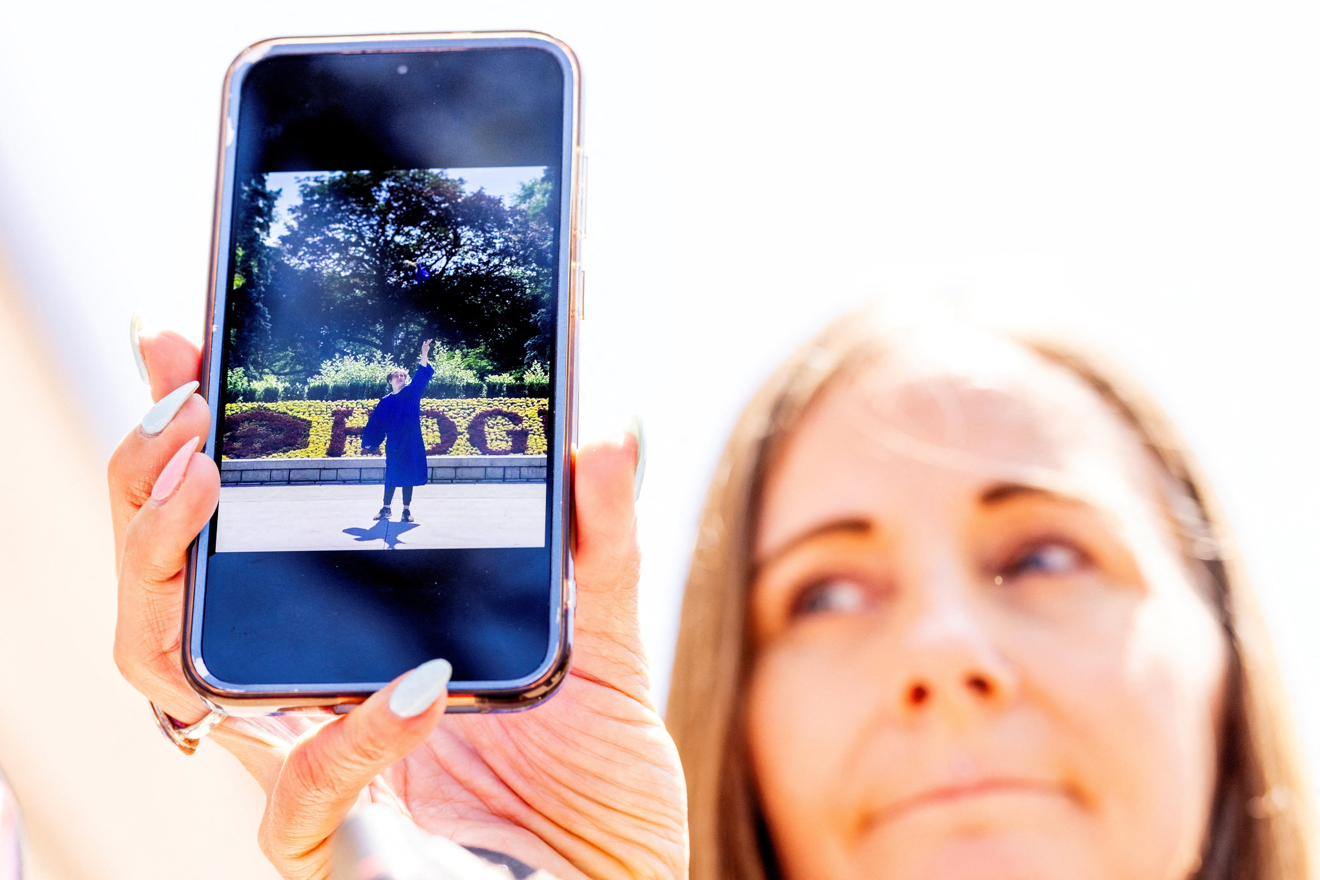 Kim Prosser shows a photo of her son Ashtyn Prosser, a victim of Kenneth Law, outside the Superior Court of Justice in Newmarket, Ontario
