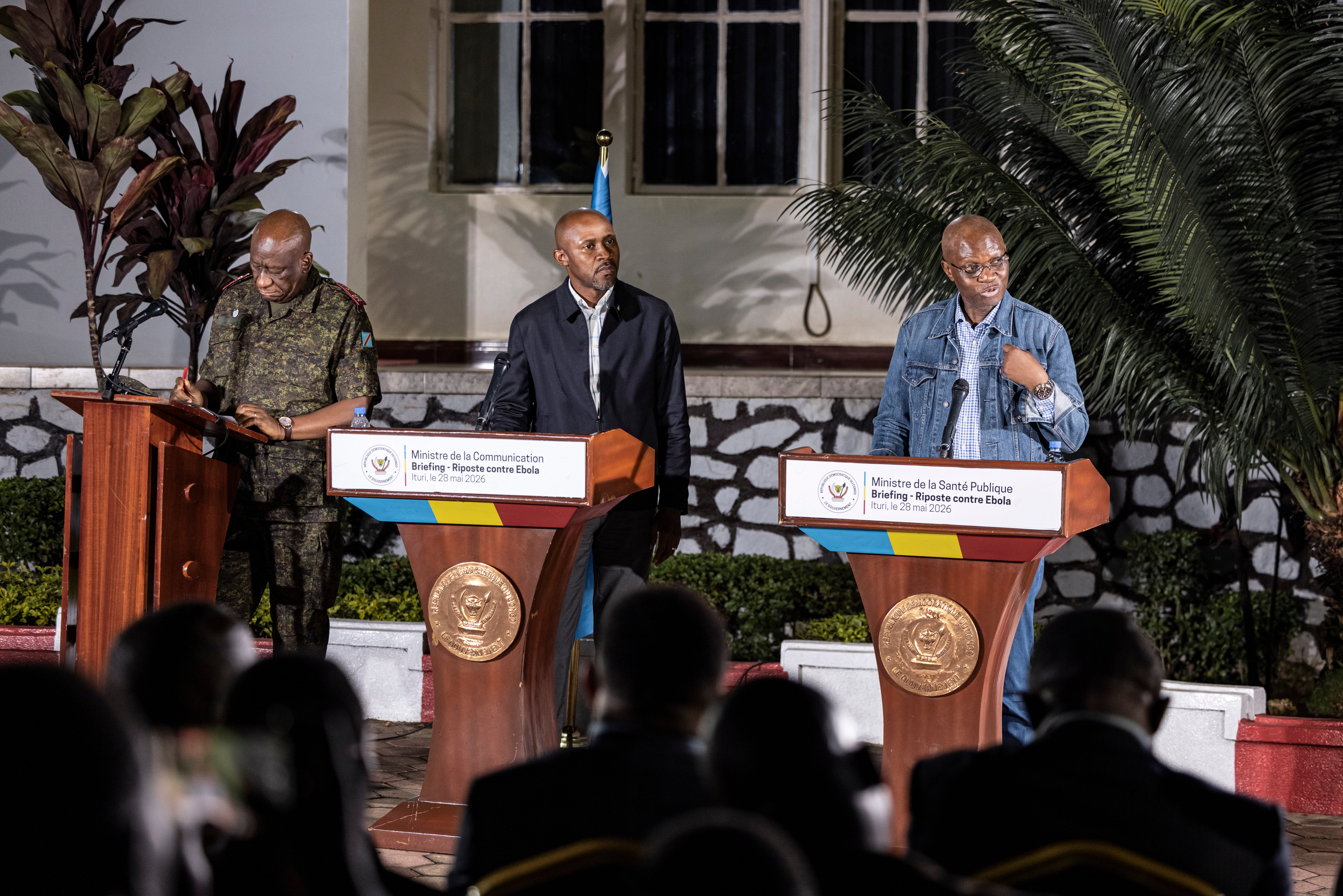 Ituri military governor Lieutenant-General Johnny Luboya Nkashama (left), Congolese Minister of Communication and Media Patrick Muyaya Katembwe (centre), and Congolese Minister of Public Health Roger Kamba (right) address the media during a press briefing on Ebola response operations