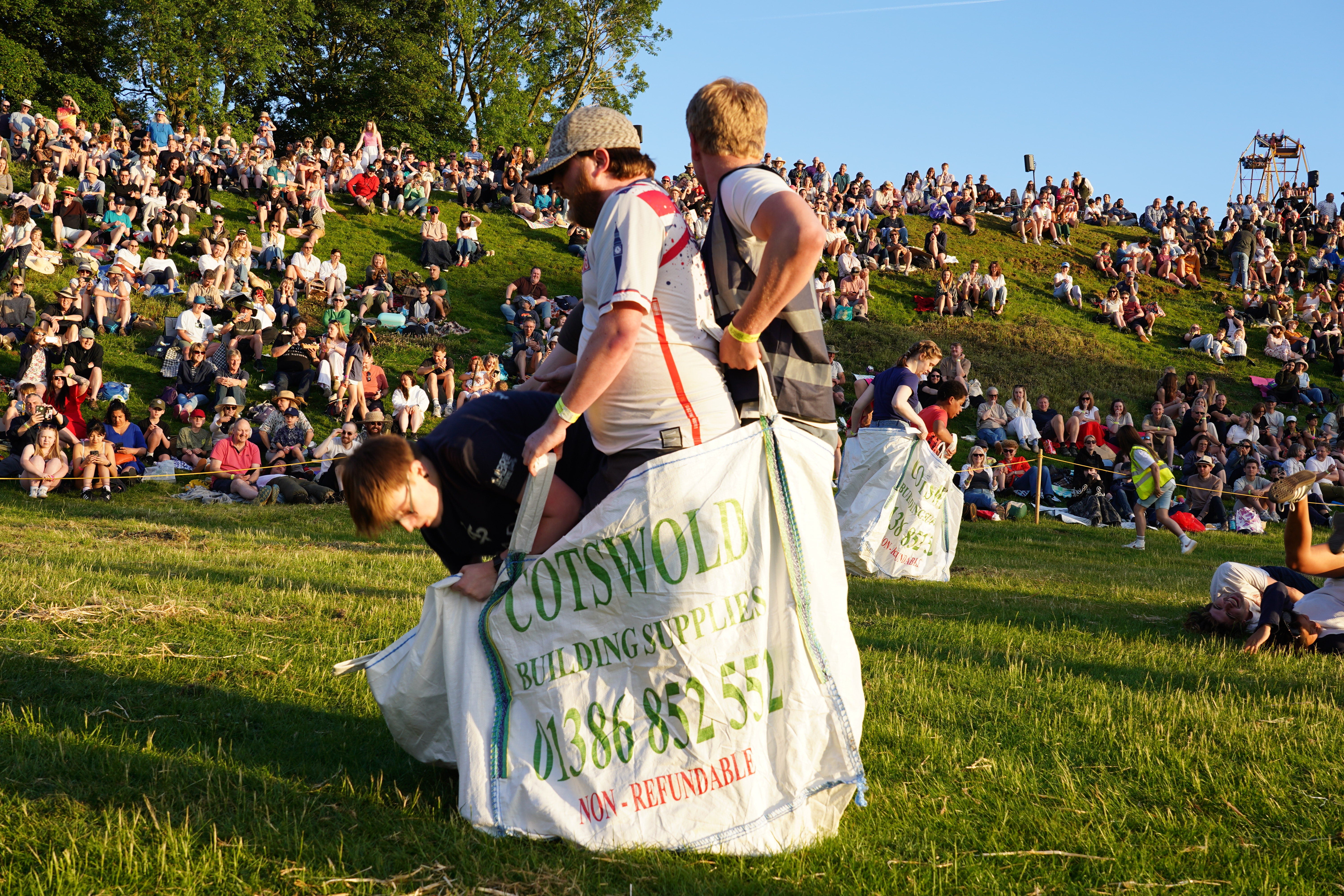 People take part in a team sack race (PA)