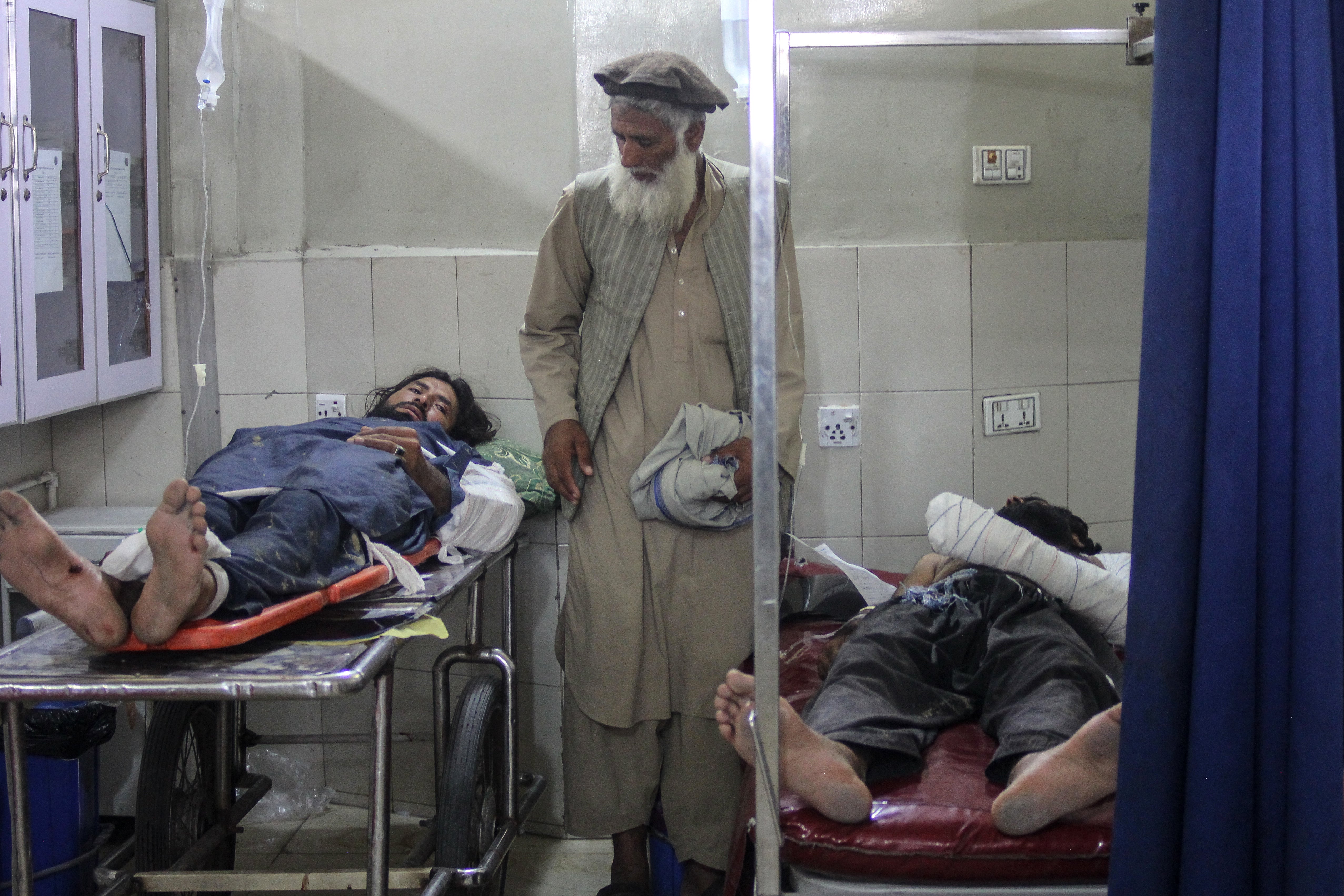 Injured people receive treatment after a truck carrying Afghan refugee families from Pakistan overturned (AFP/Getty)
