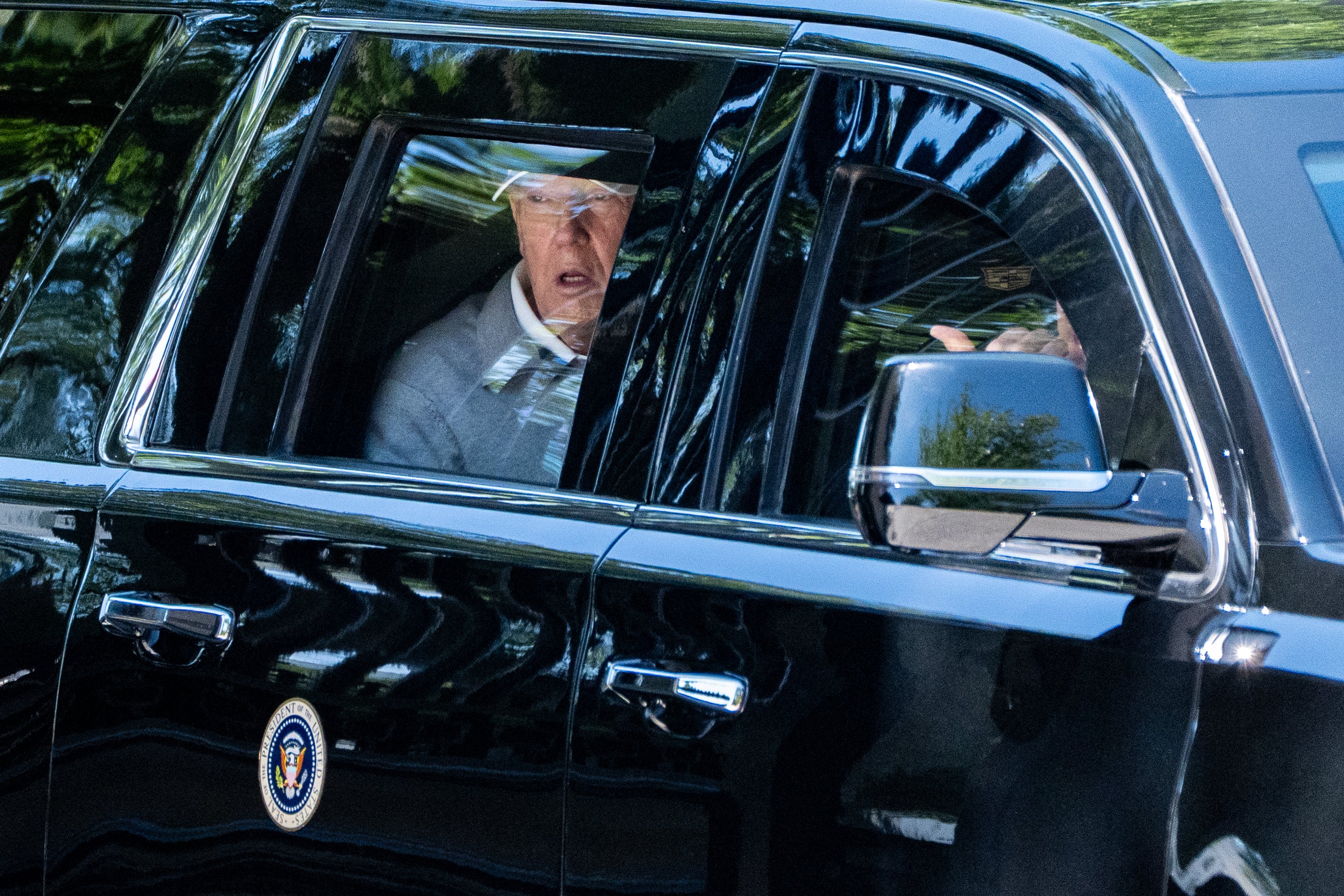 President Donald Trump looks out the window of his limousine at the construction in Lafayette Park as he departs the White House on Saturday — the closest he came to a public appearance over the weekend