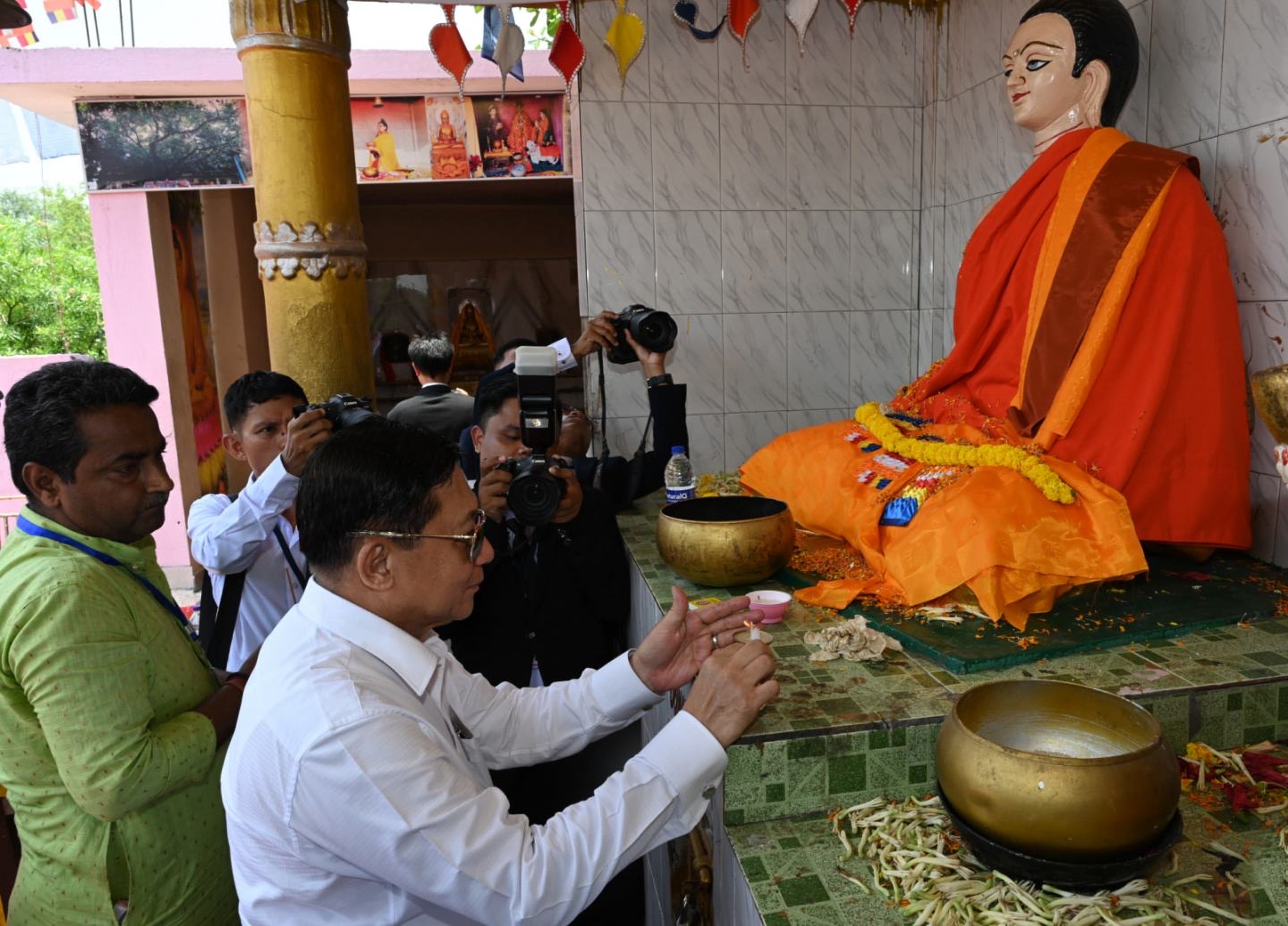 Myanmar President Min Aung Hlaing offers candles in front of a Buddha statue as he visits Bodh Gaya