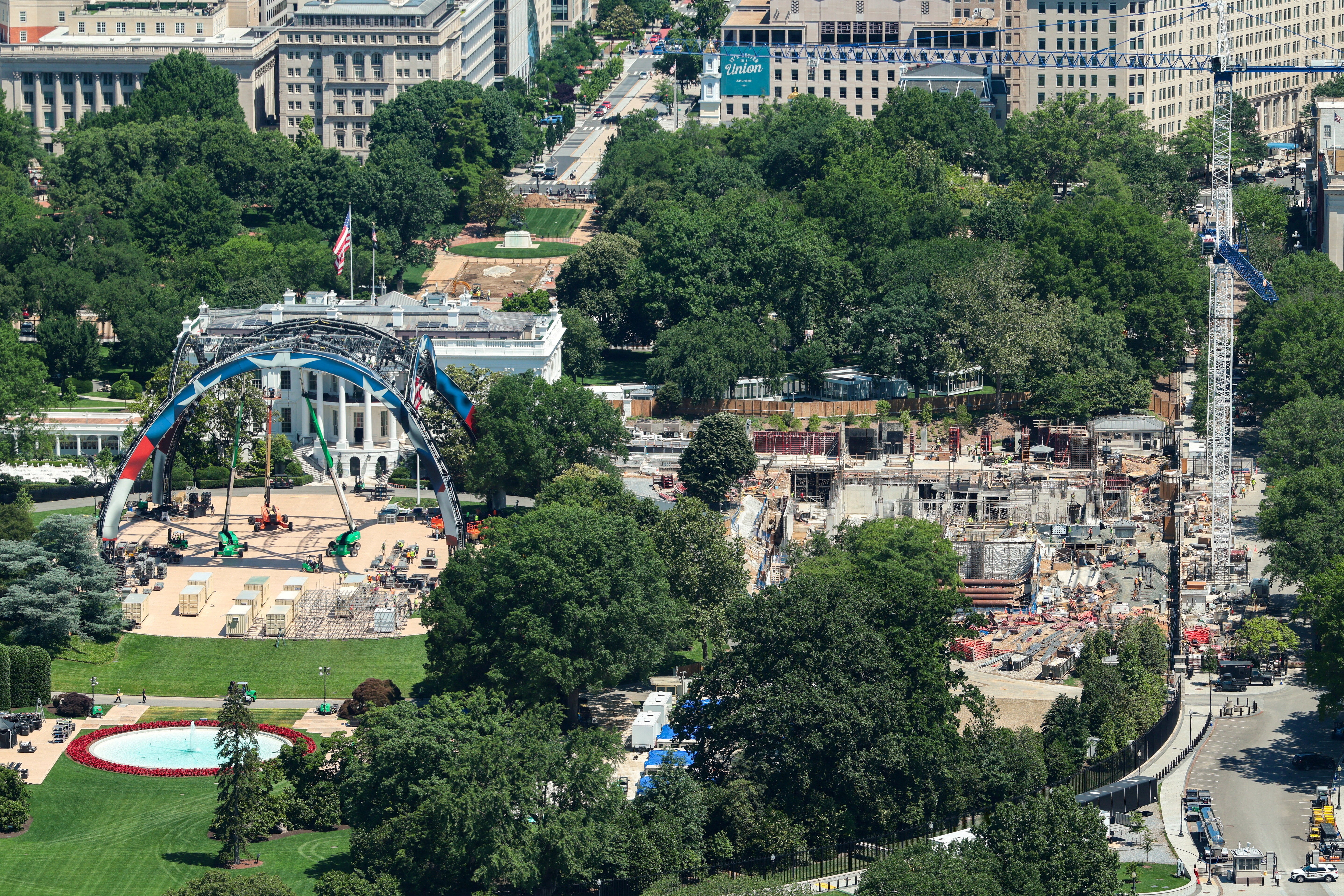 Construction continues at the site of President Donald Trump's new ballroom at the White House as workers prepare a ring for a UFC fight on the South Lawn