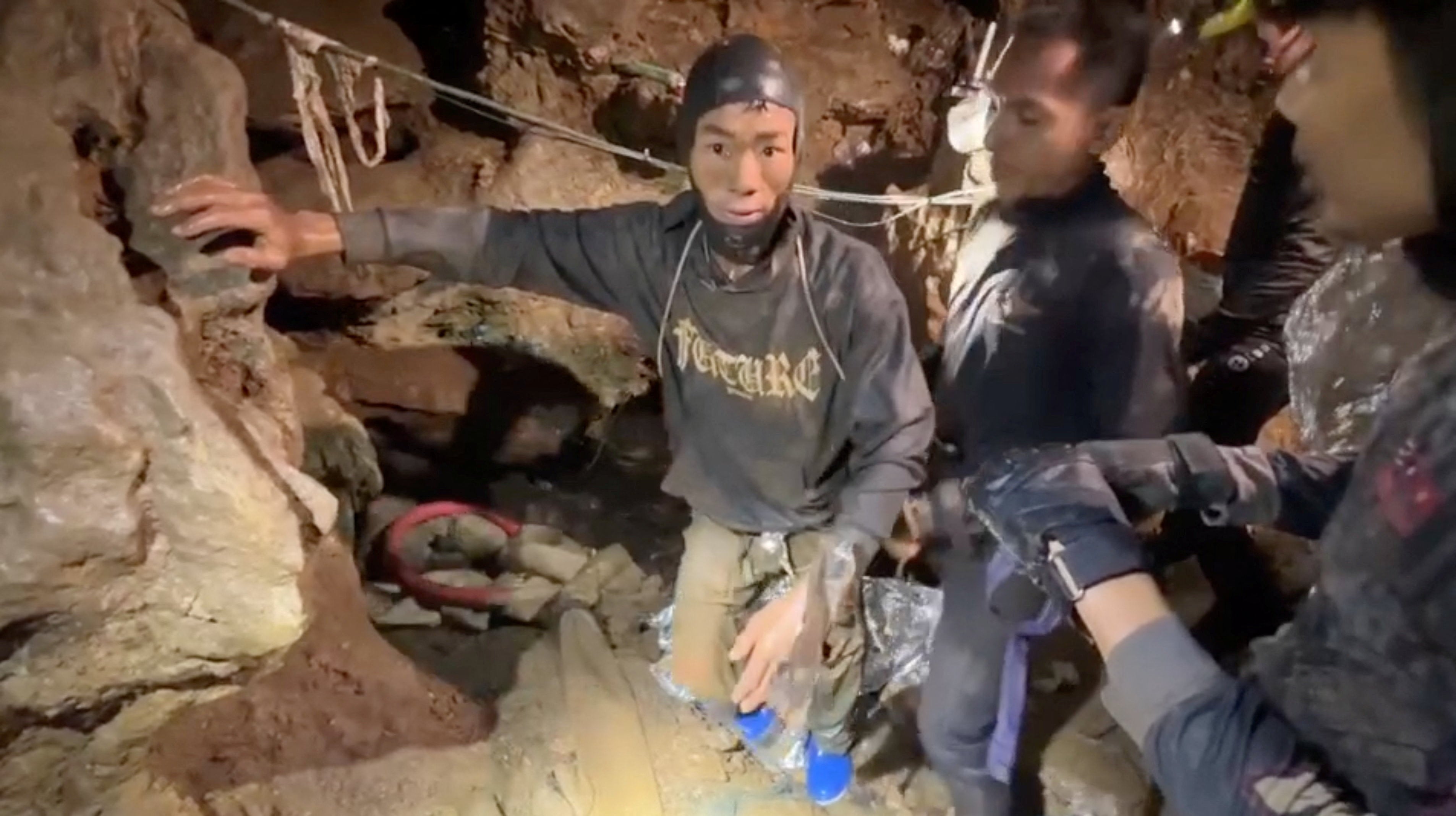 Rescuers pull out the first trapped person from a flooded cave in Laos on 29 May 2026