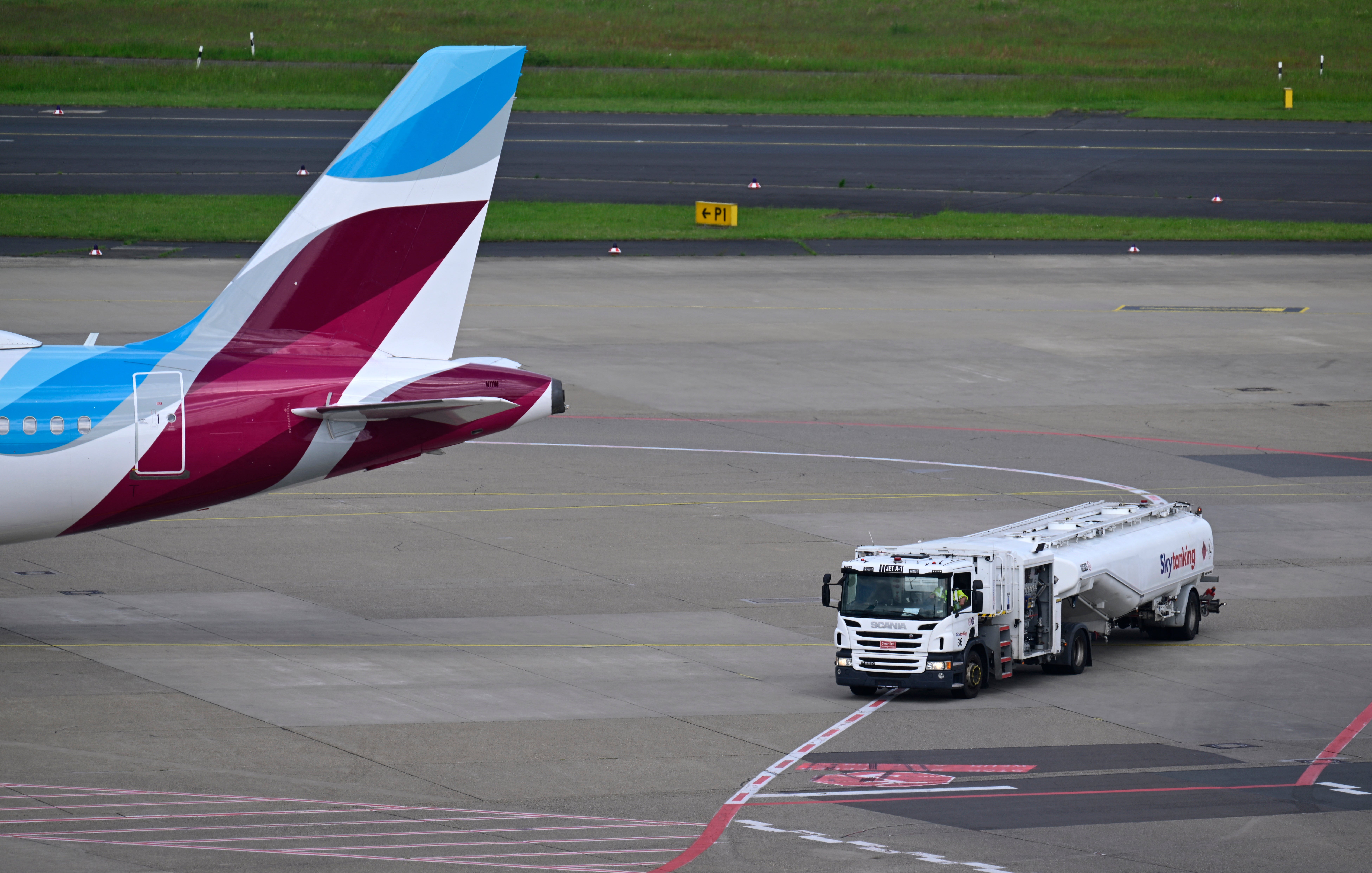 Jet fuel is transported by a tank truck to a Eurowings aircraft at the airport in Düsseldorf, western Germany, on 21 May 2026. The war in the Middle East and the closure of the Strait of Hormuz have caused a surge in aviation fuel prices and raised concerns about potential shortages this summer