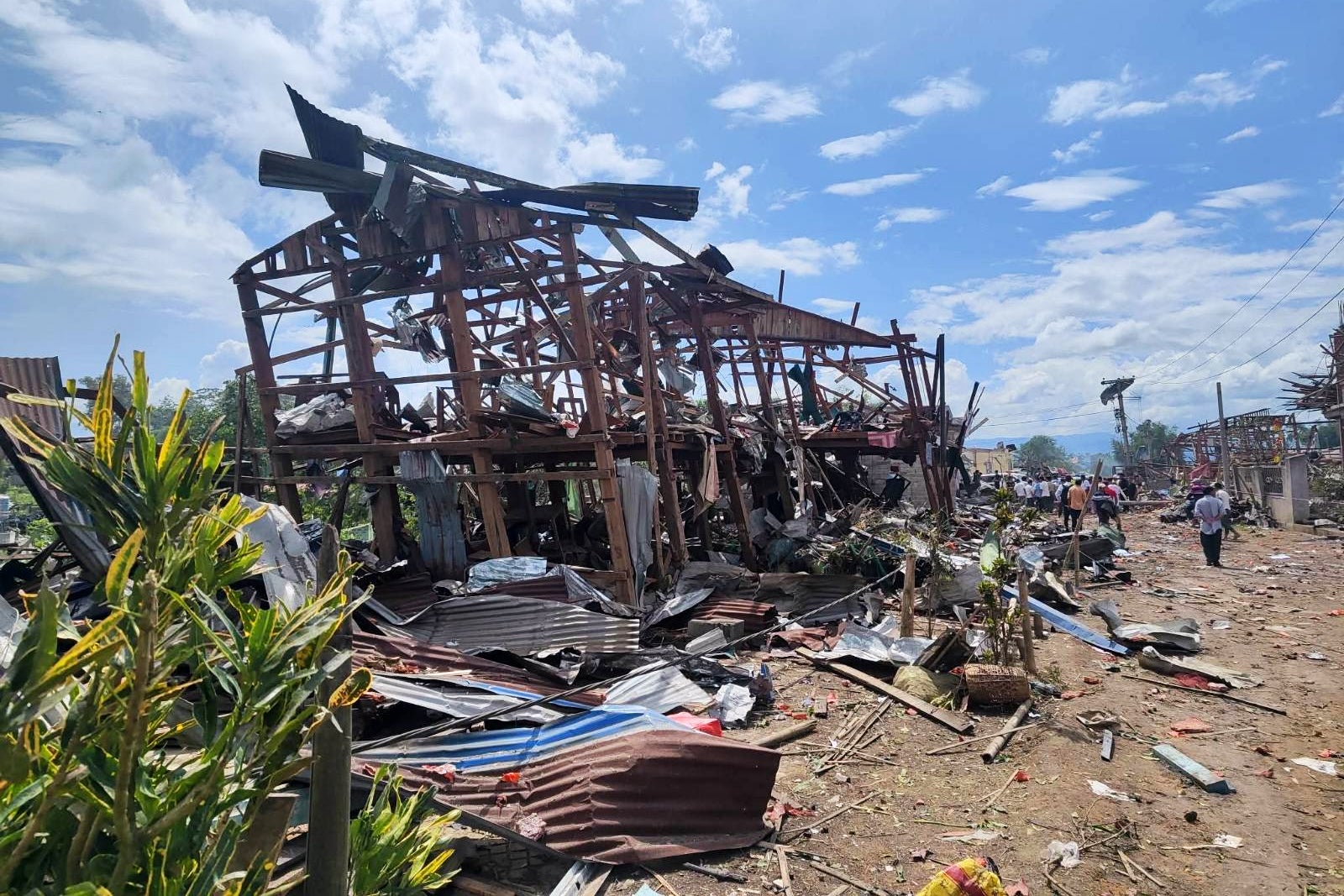 Rescuers and local residents carrying out search operations in the aftermath of an explosion in Kaungtup village in Namhkam township in Shan state, (AP)