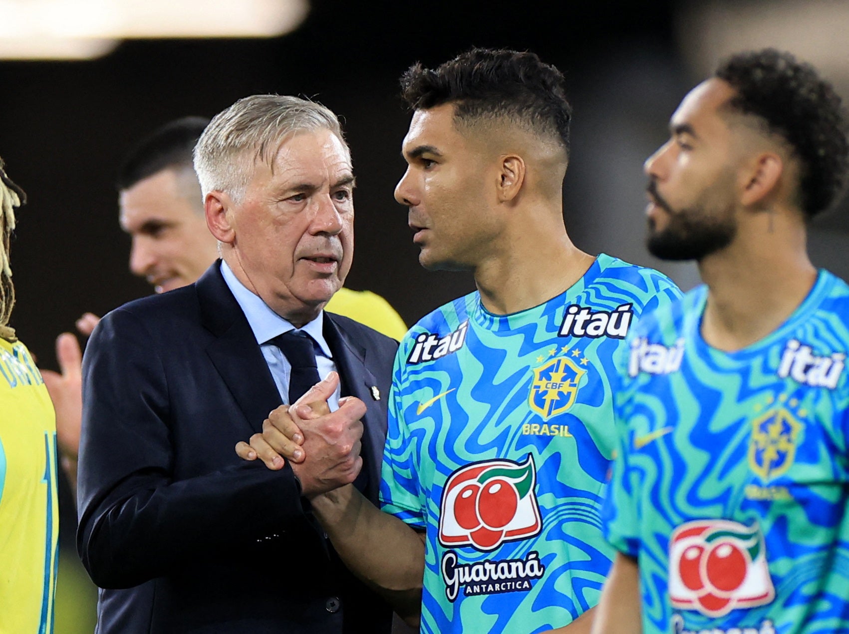 Brazil coach Carlo Ancelotti shakes hands with Casemiro after the match