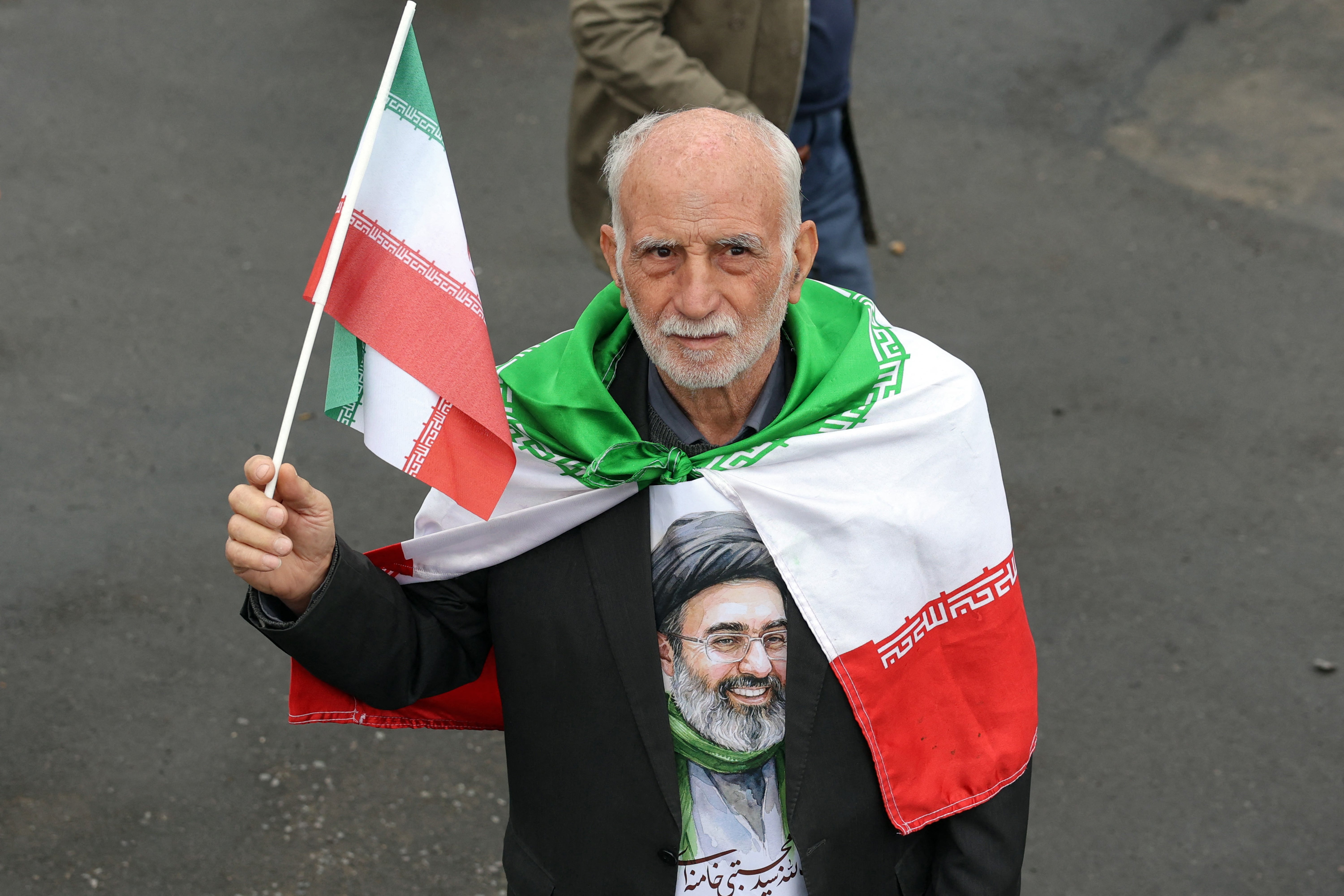 An Iranian demonstrator taking part in a march during the funeral ceremony for Iran's slain intelligence minister Esmail Khatib in March 2026. (AFP/Getty)
