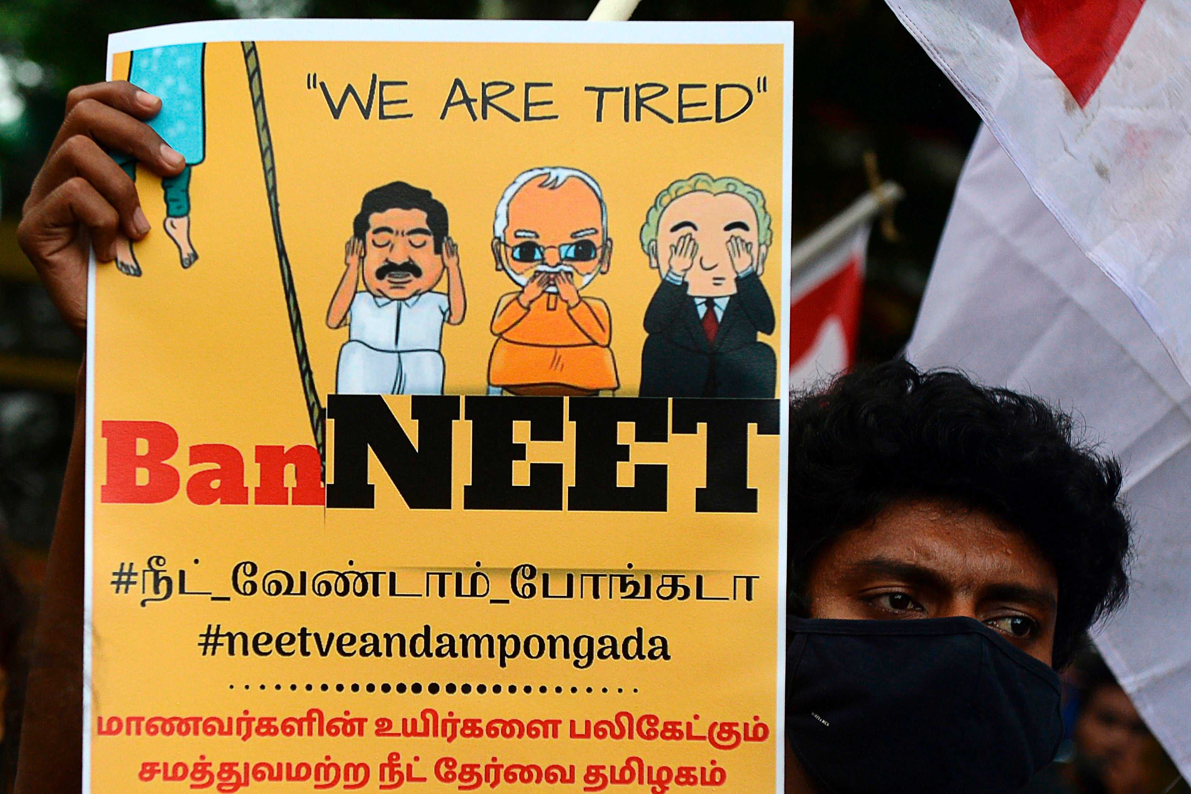 File: A member of the Democratic Youth Federation of India (DYFI) holds a placard and shouts slogans against the National Eligibility Cum Entrance Test (NEET)
