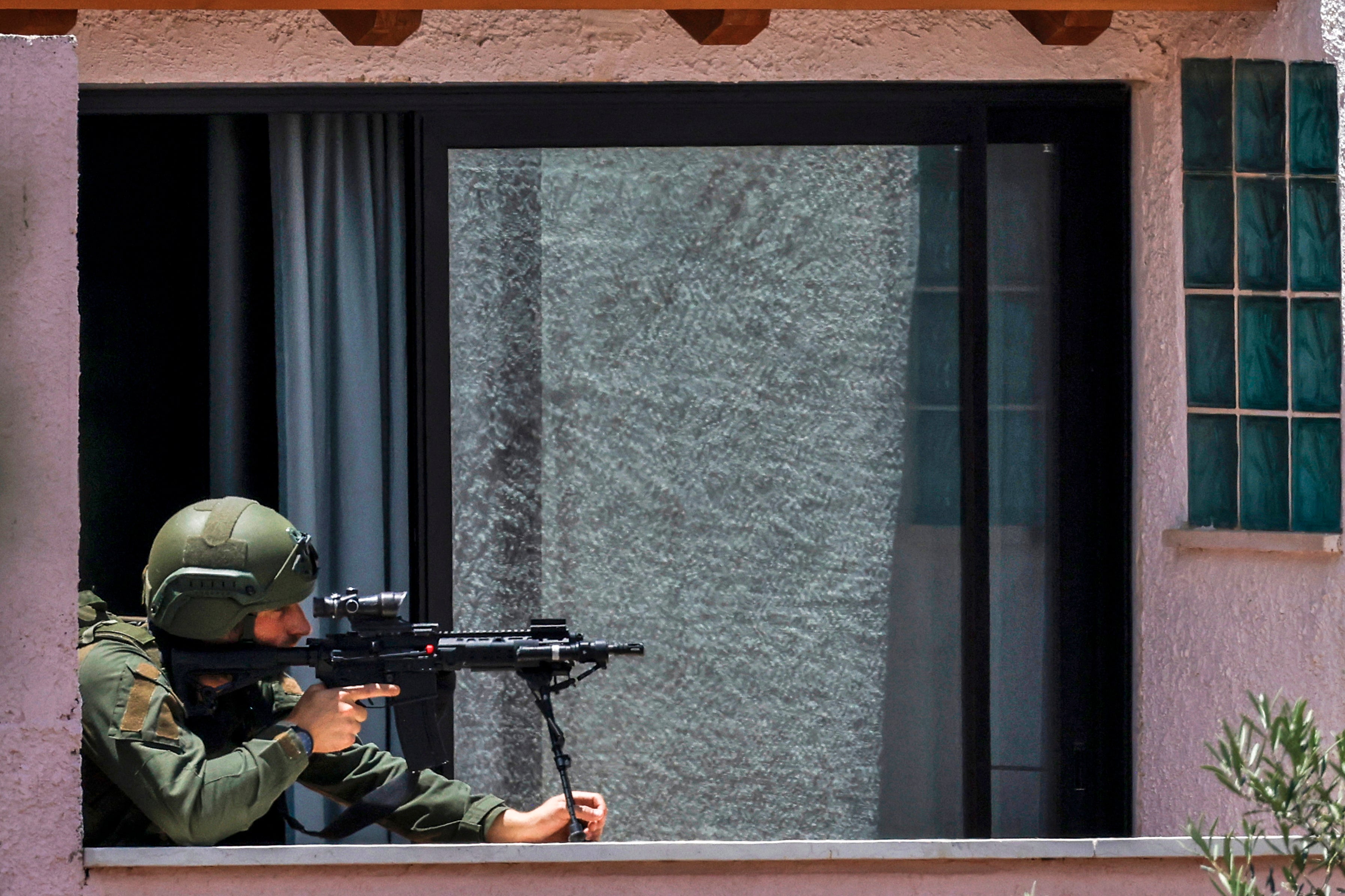 This picture taken from a position in northern Israel on the border with southern Lebanon shows an Israeli soldier taking position on the balcony of a building on May 31, 2026. (AFP/Getty)