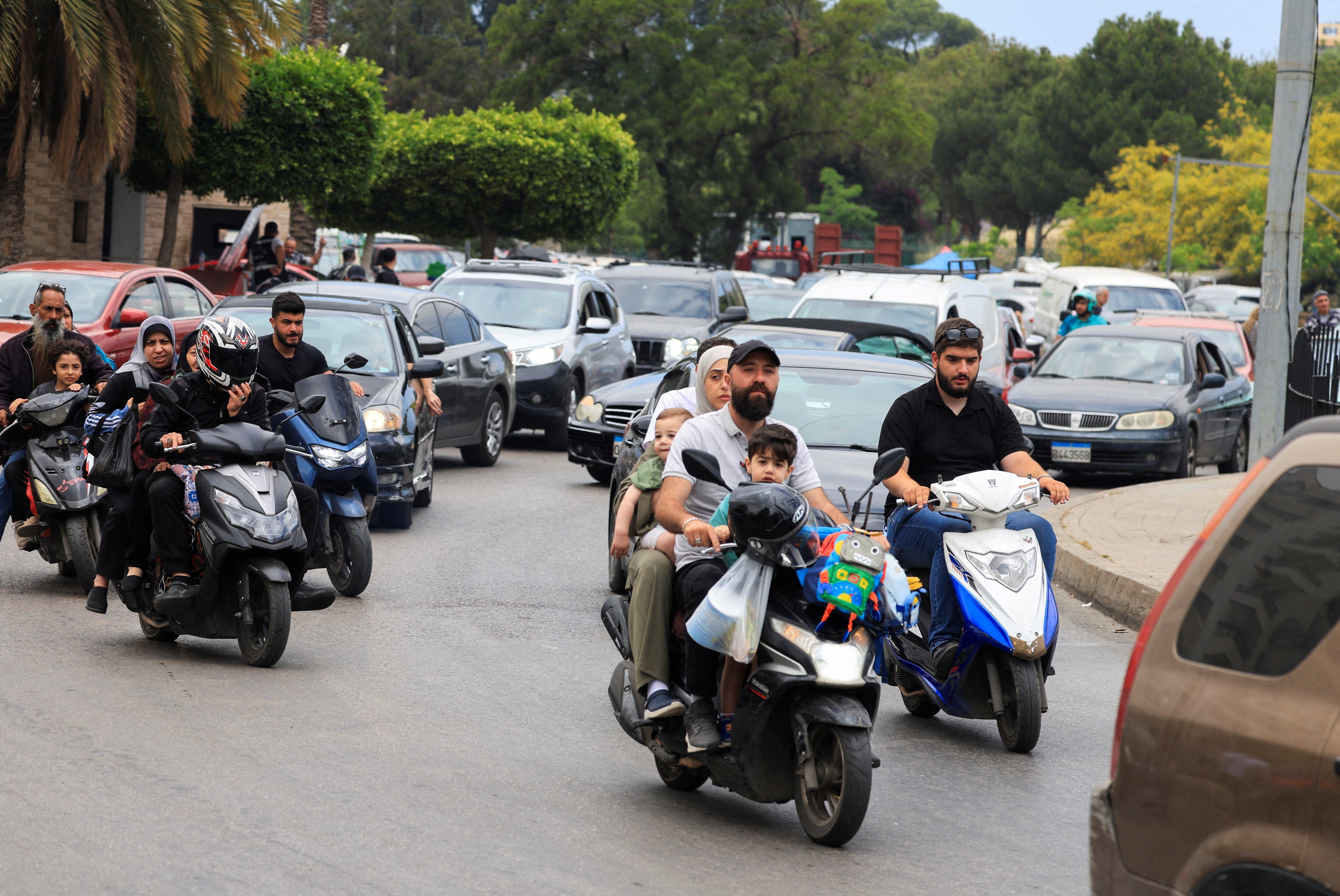 People make their way on scooters as they flee the southern suburbs of Beirut, after Israeli prime minister Benjamin Netanyahu ordered the military to attack targets, on 1 June