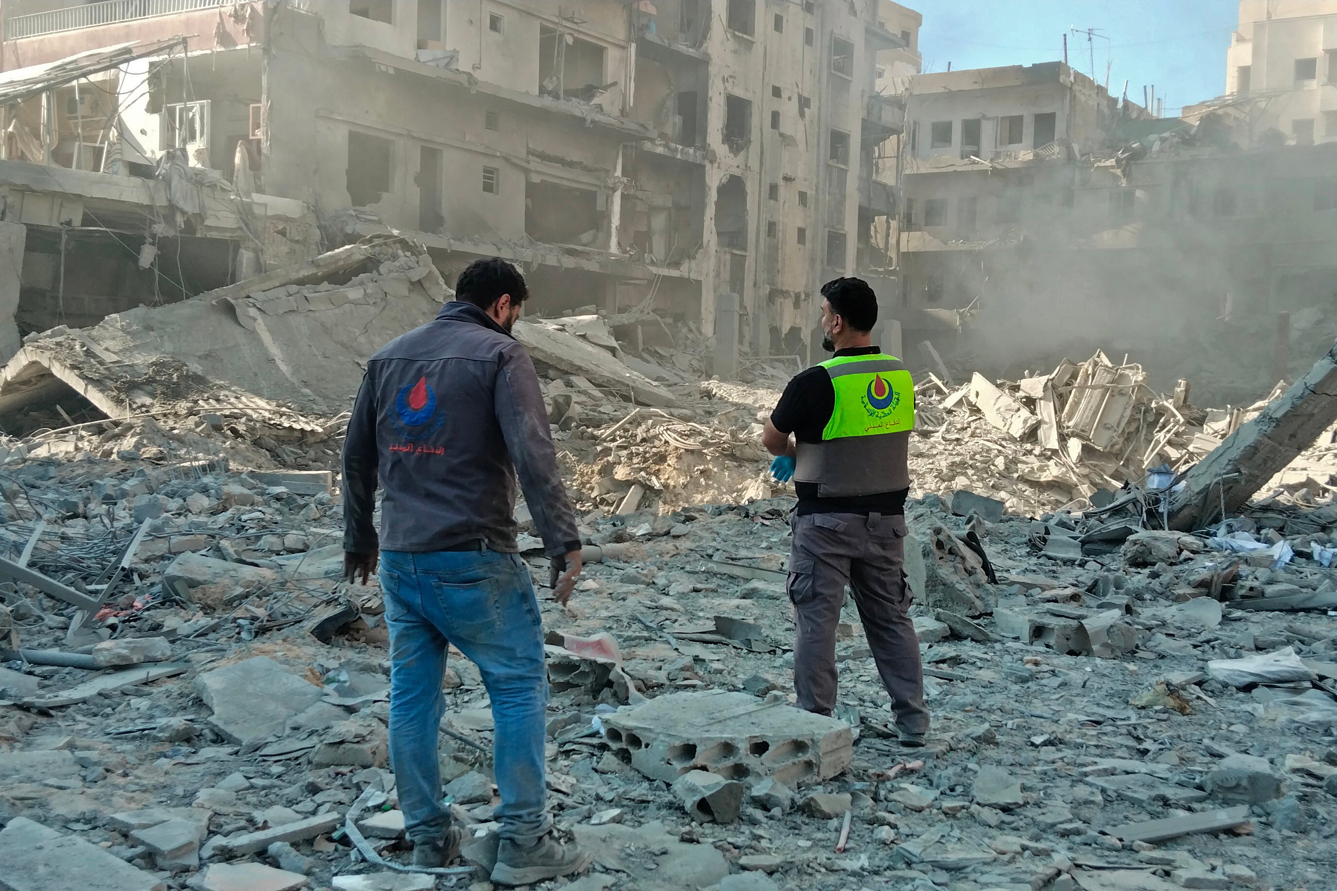 Civil defence workers inspect the site of an Israeli strike in the southern Lebanese city of Tyre on 31 May