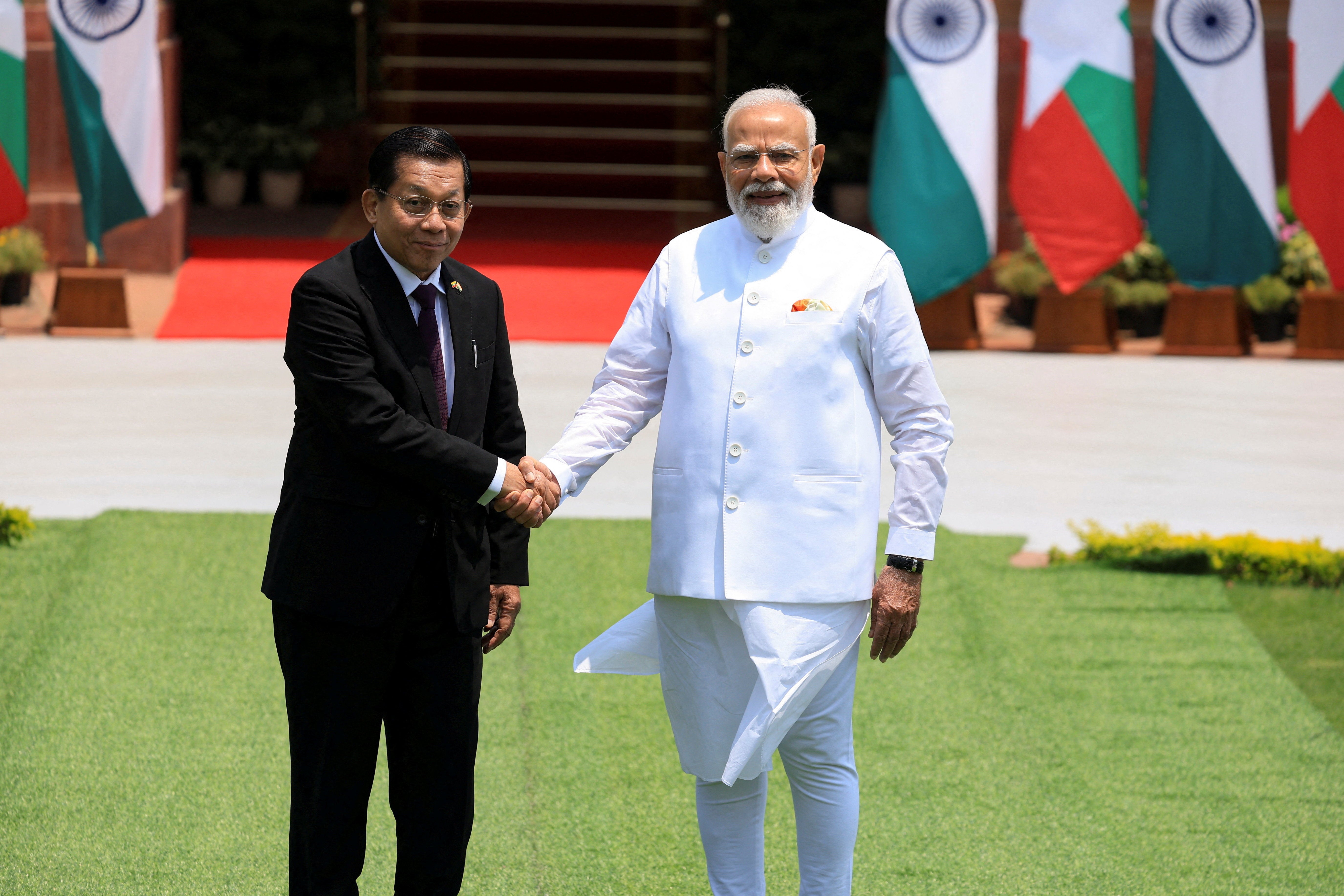 Myanmar's President Min Aung Hlaing shakes hands with India's Prime Minister Narendra Modi before their meeting at the Hyderabad House