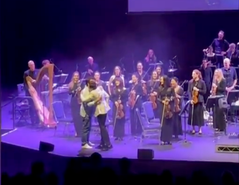 A member of the audience is called up to join the orchestra at 'La La Land in Concert' in Sydney