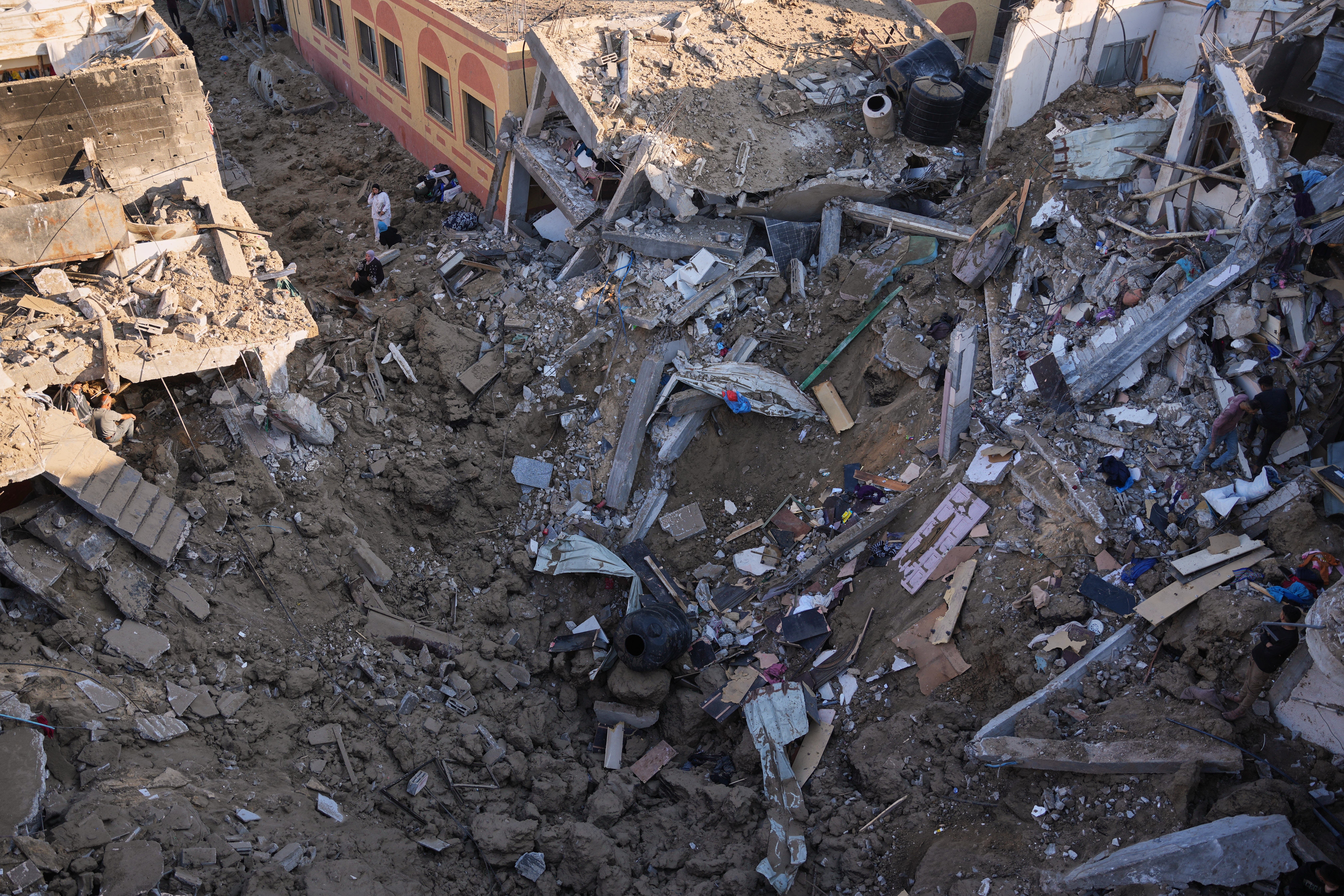 Palestinian women inspect the rubble of a building destroyed in an Israeli airstrike in Deir al-Balah, in the central Gaza Strip, Friday, May 29, 2026 (AP)