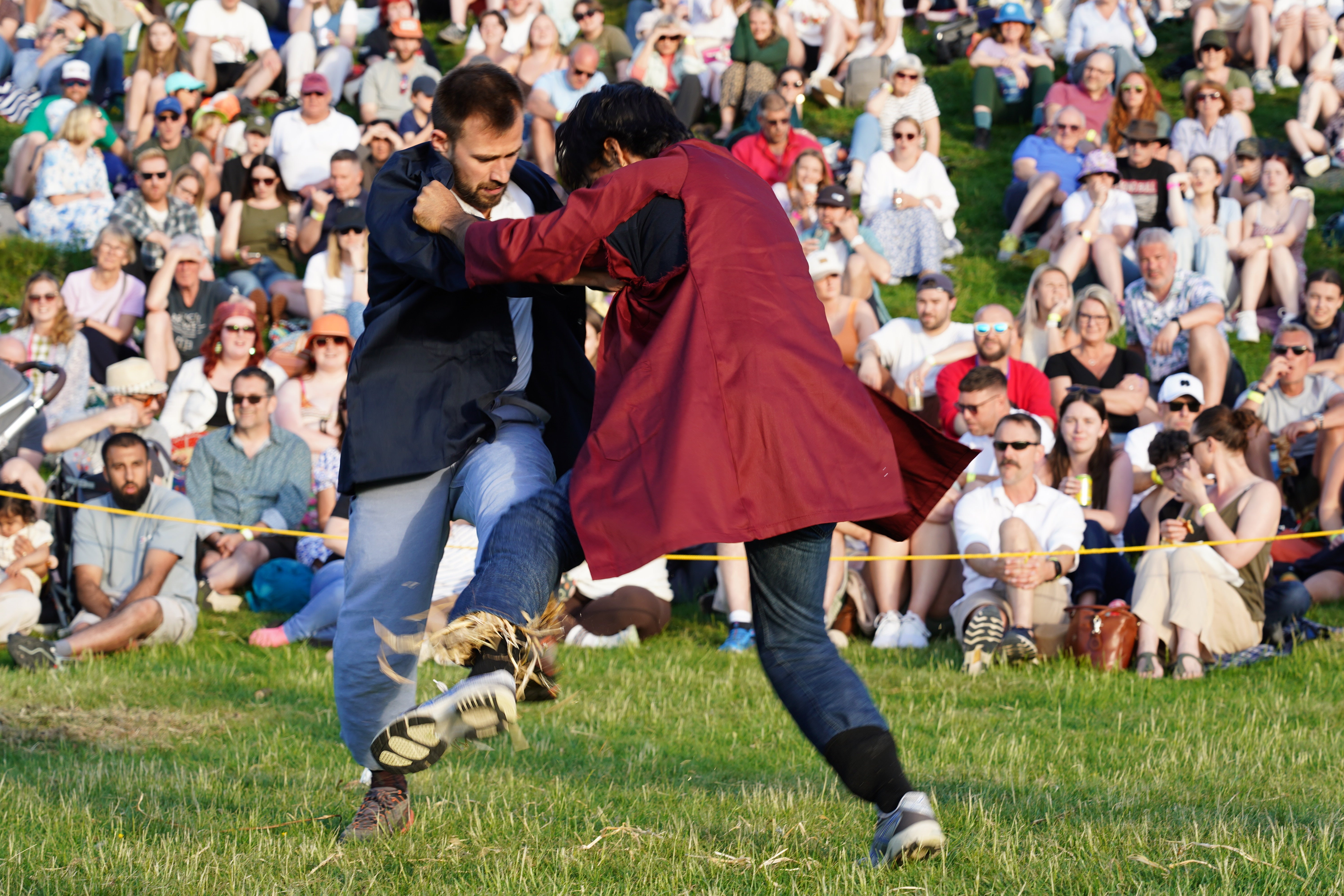 People take part in four centuries-old Cotswold Olimpick Games in Chipping Campden, Gloucestershire, famous for their shin-kicking competition (PA)