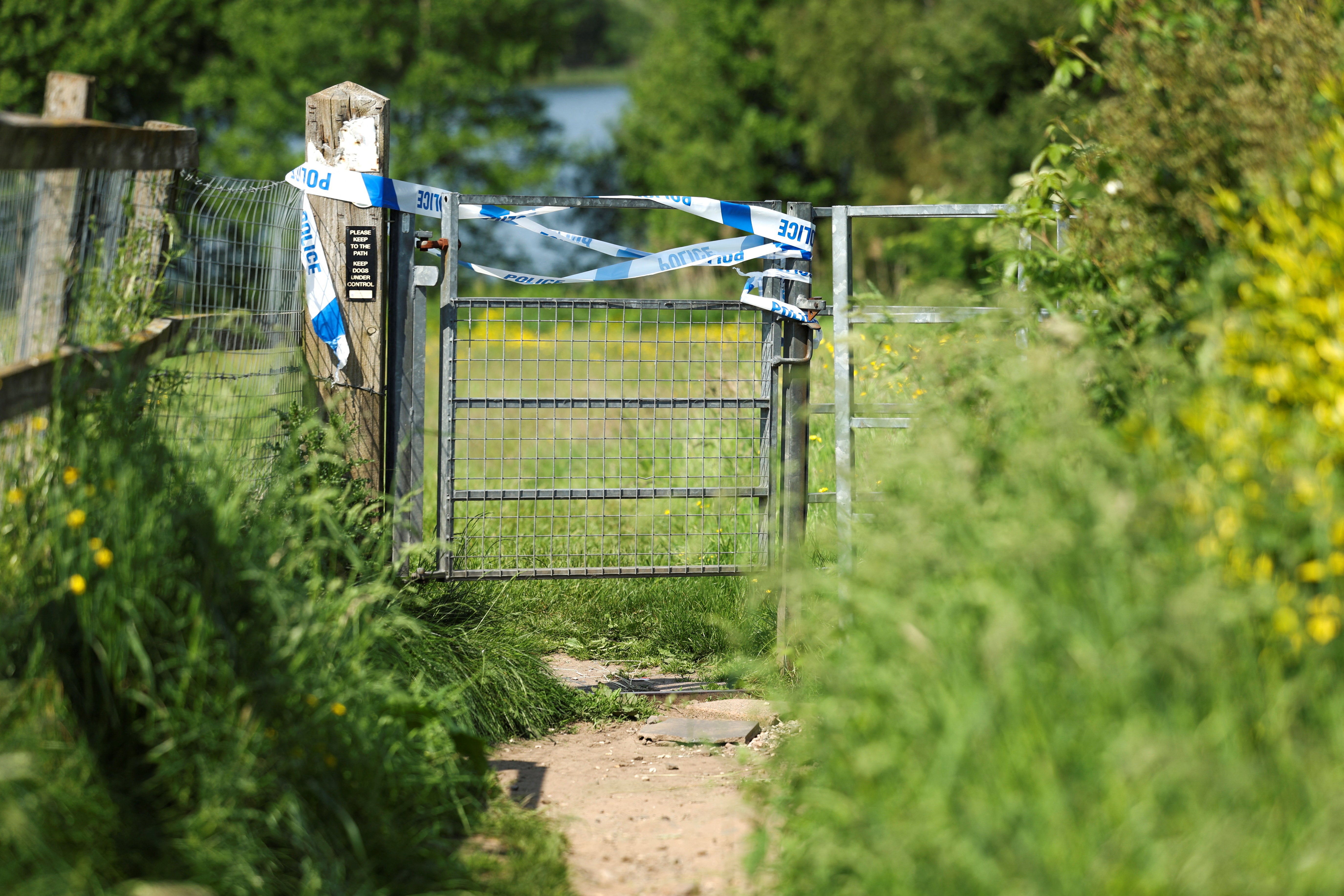 A cordon is drawn at Pickmere Lake where emergency services recovered the body of a boy believed to be a missing 17-year-old, a day after the UK recorded its hottest ever May temperature