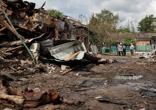 Residents look at houses damaged by a Russian drone strike in Odesa, Ukraine, June 1, 2026