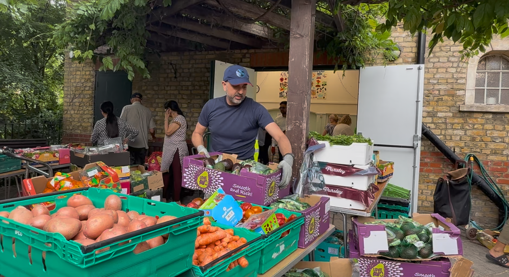 Khalil Mohammed, volunteer at Rotherhithe Community Kitchen, helps set up the food bank