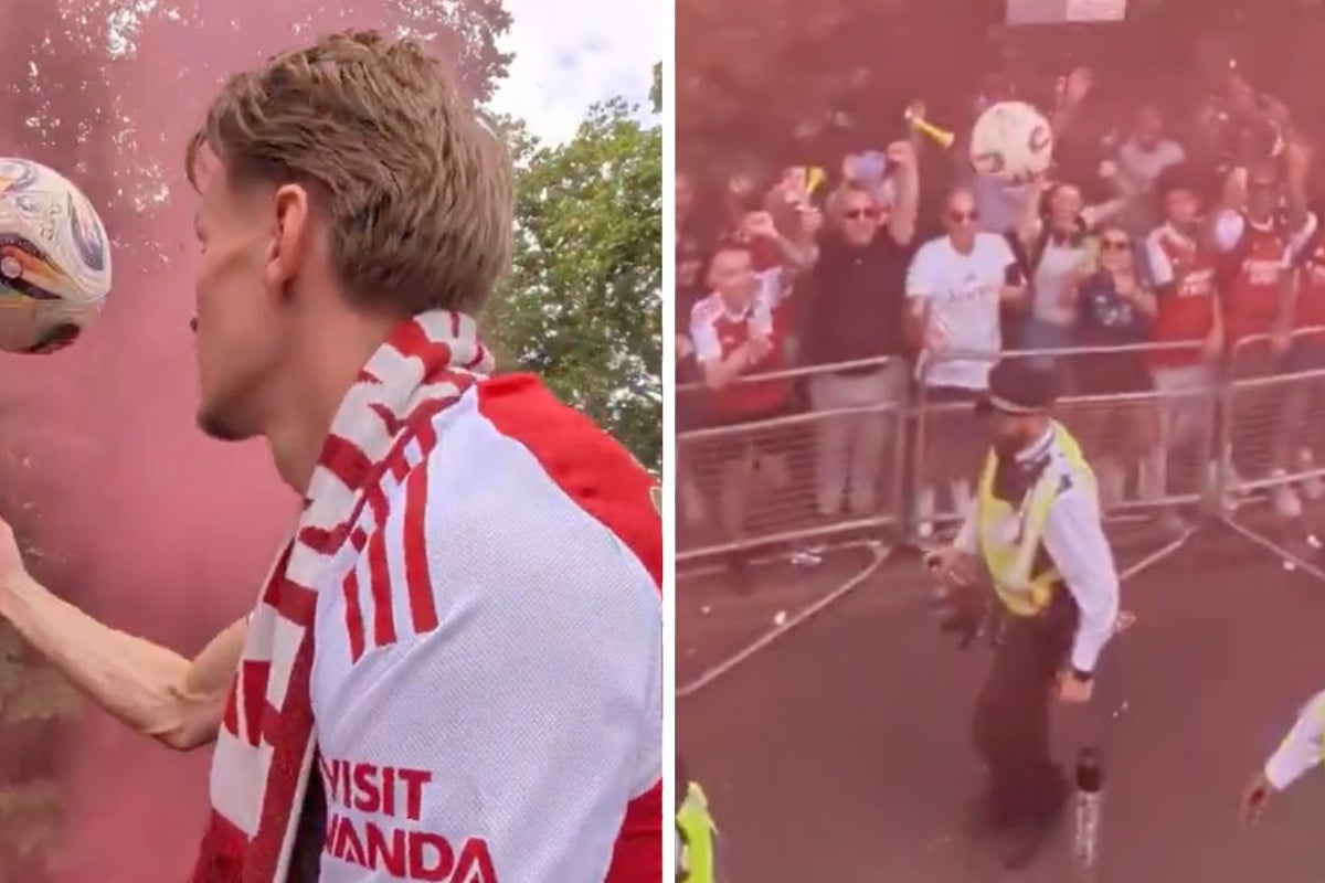 Arsenal’s Martin Ødegaard accidentally hits police officer on head with football during parade