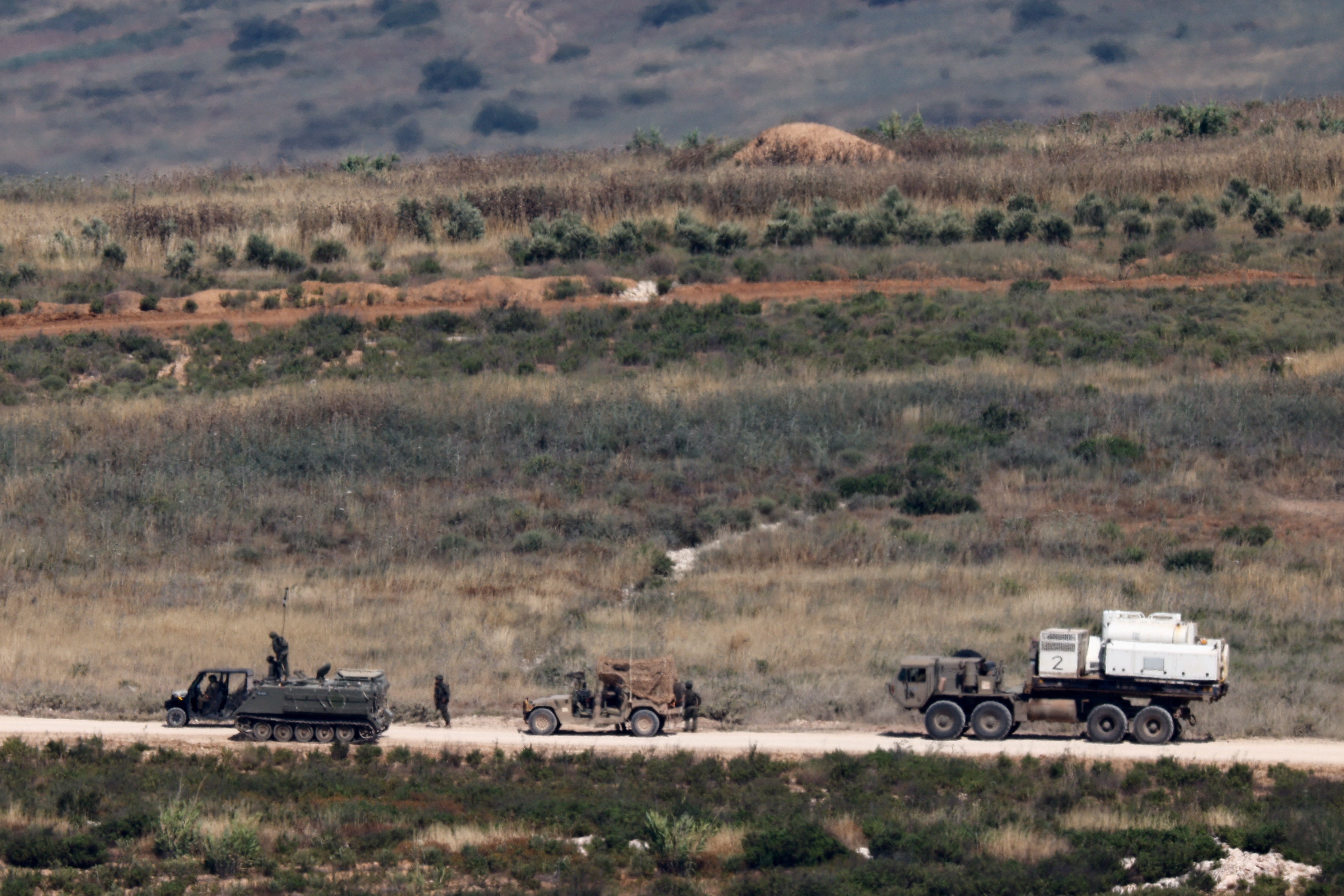 Israeli soldiers near military vehicles in Lebanon, as seen from the Israeli side of the Israeli-Lebanese border, June 1, 2026. (Reuters)