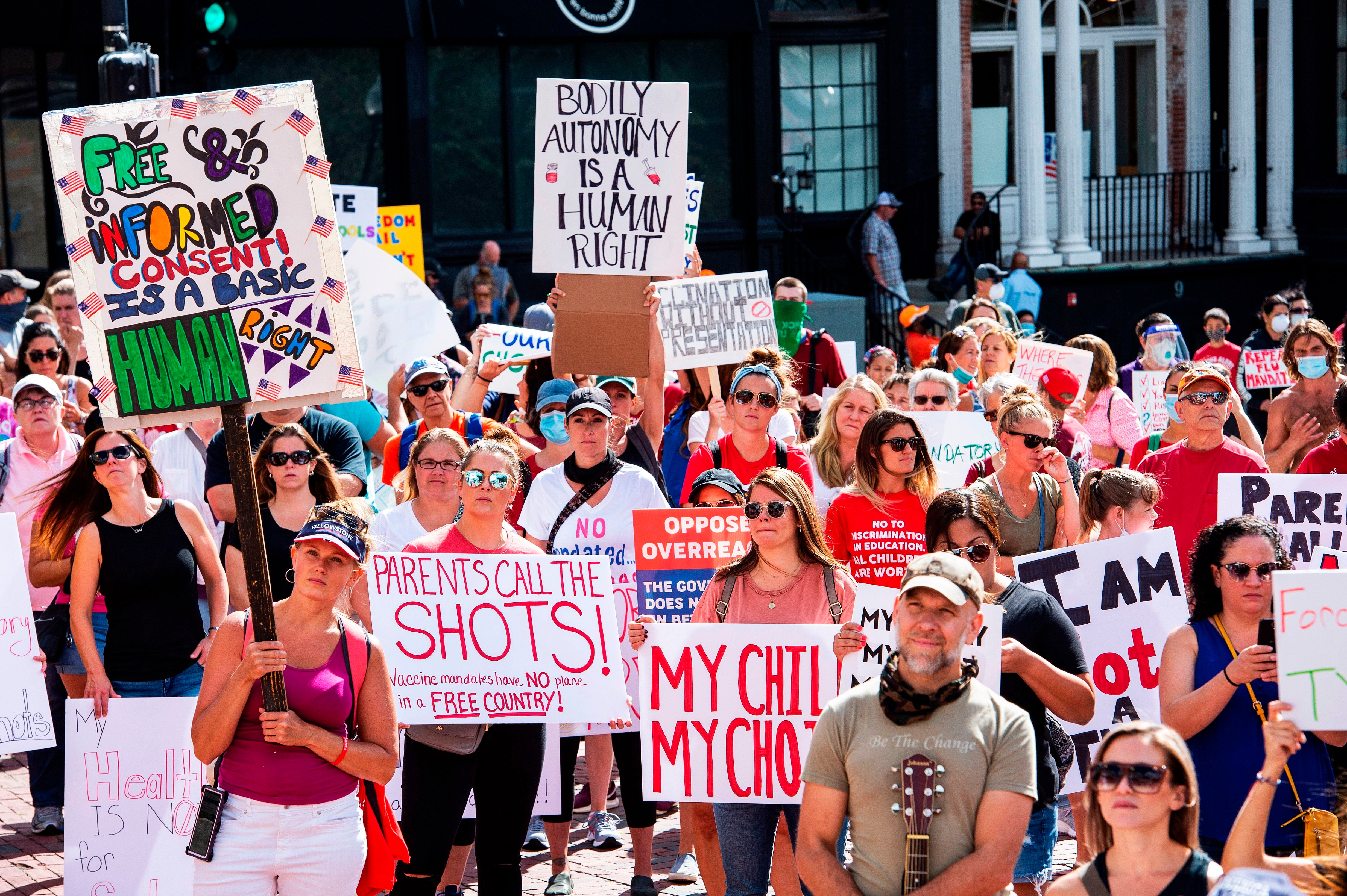 People attend a Boston protest against a Massachusetts mandate requiring flu shots to attend school in August 2020. Vaccine hesitancy fueled by misinformation has led to lowered child vaccination rates