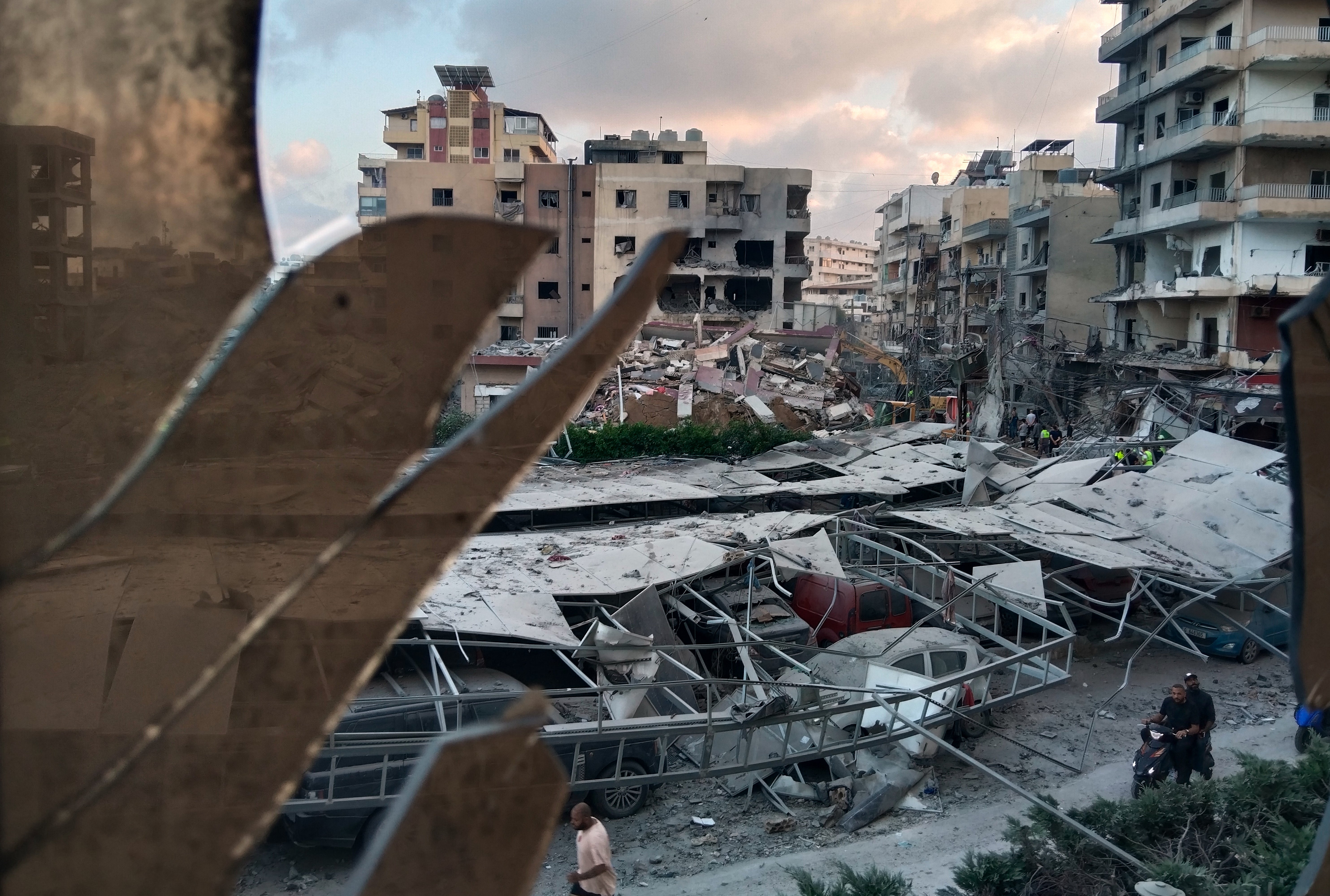 A Lebanese hospital is in ruins and people flee a Beirut suburb after Israel's threat, in photos