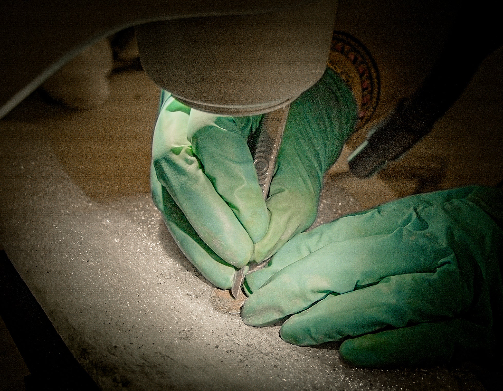 Archaeologist Lucie Altenburg examines a coin under a microscope after it was discovered during excavations outside Notre-Dame Cathedral