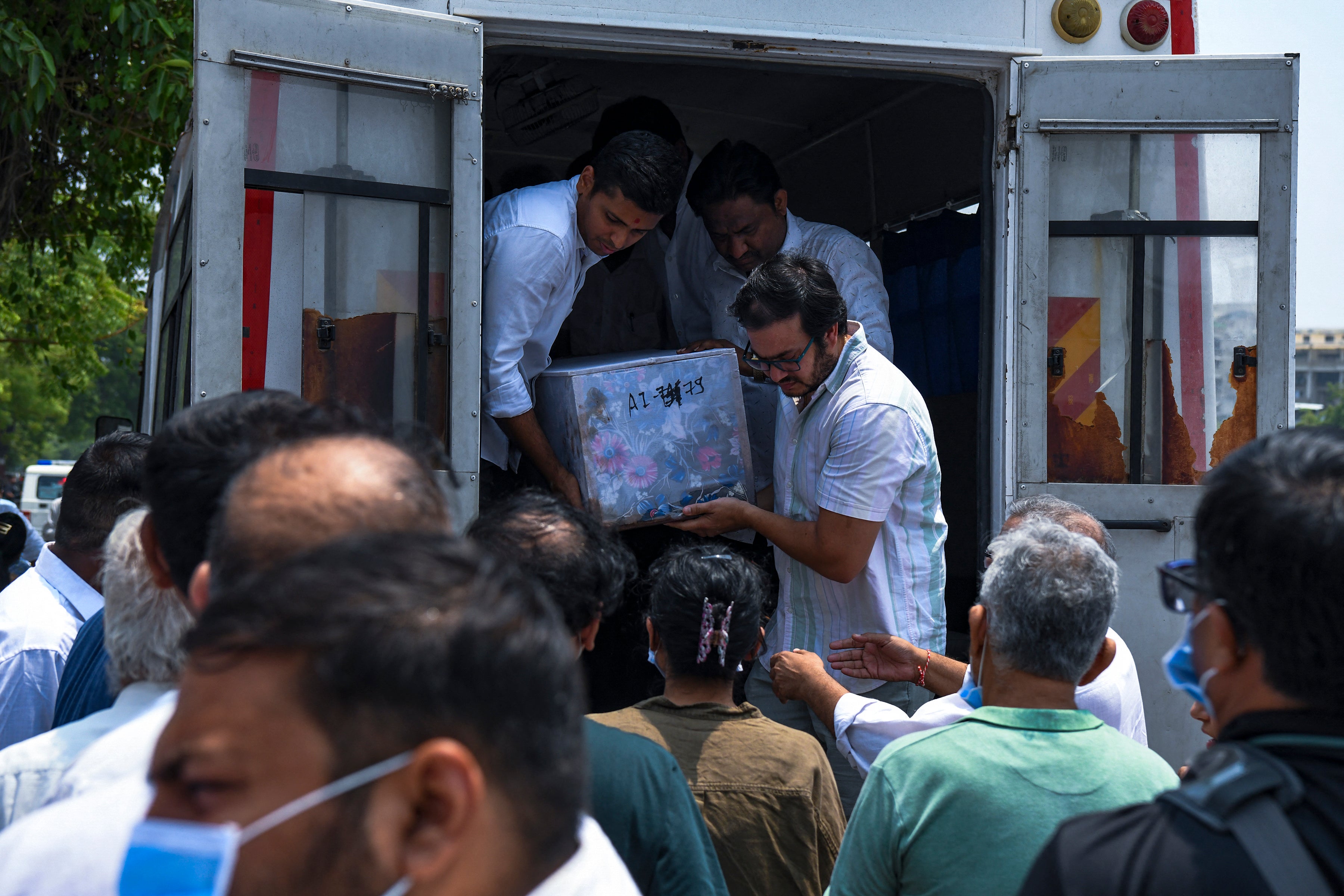 Relatives unload a coffin containing the remains of Megha Mehta, a victim of the Air India plane crash, during her funeral in Ahmedabad, India, on 15 June 2025