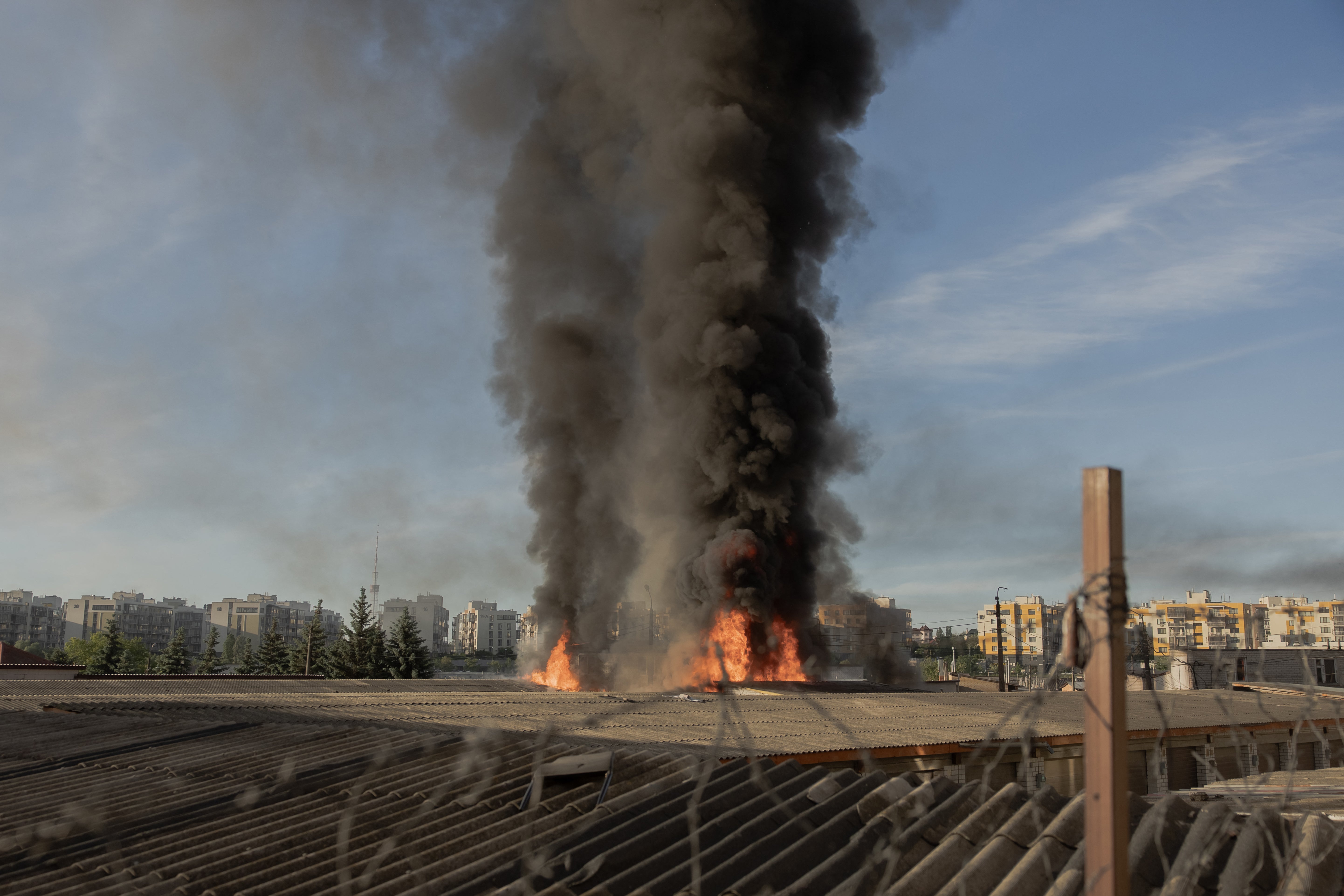Smoke and flames rise from garages damaged during a Russian missile and drone strikes in Kyiv (AFP/Getty)