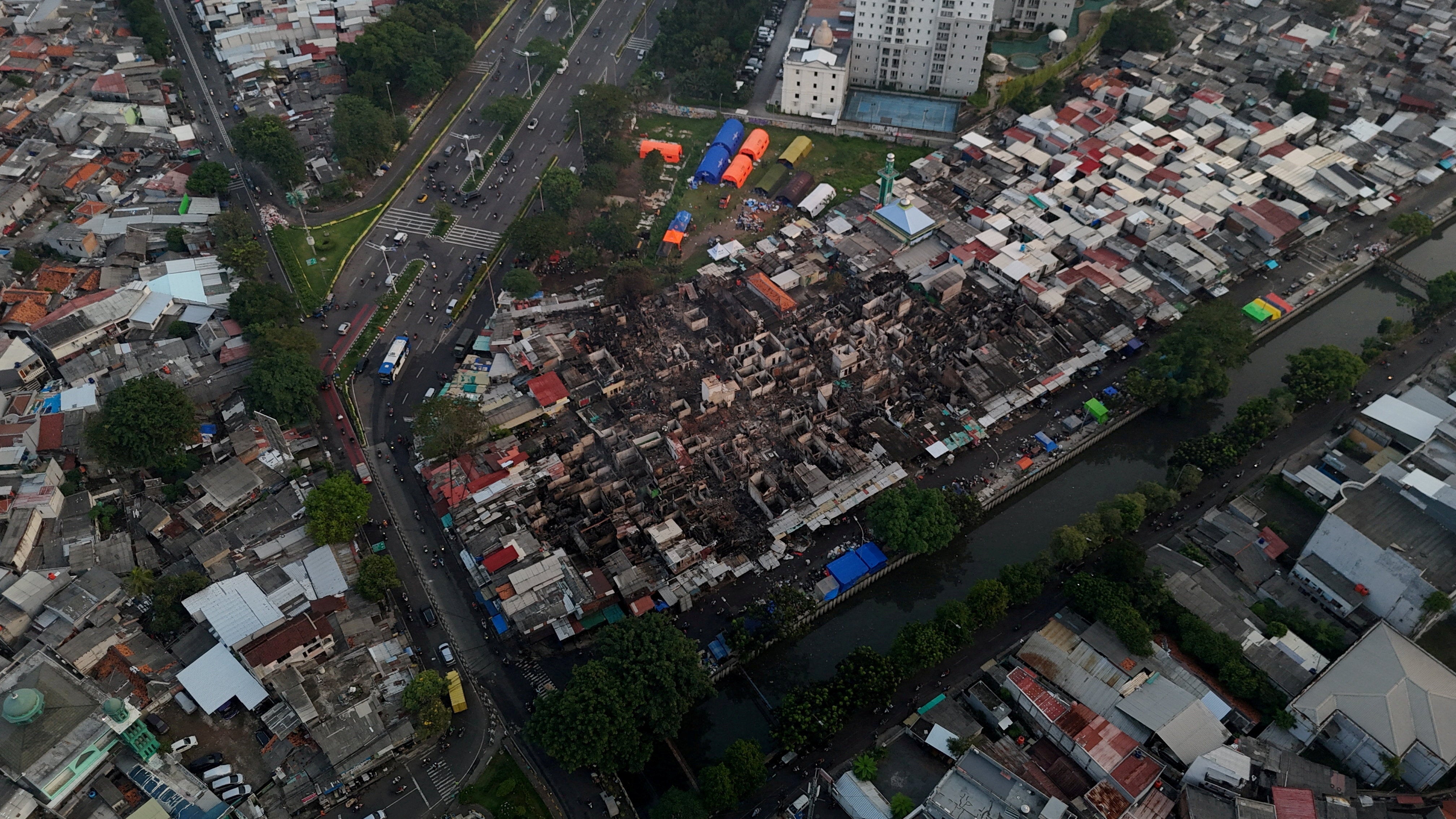 A drone view of people gathering at the site after a fire broke out at the Jiung market, in Jakarta (Reuters)