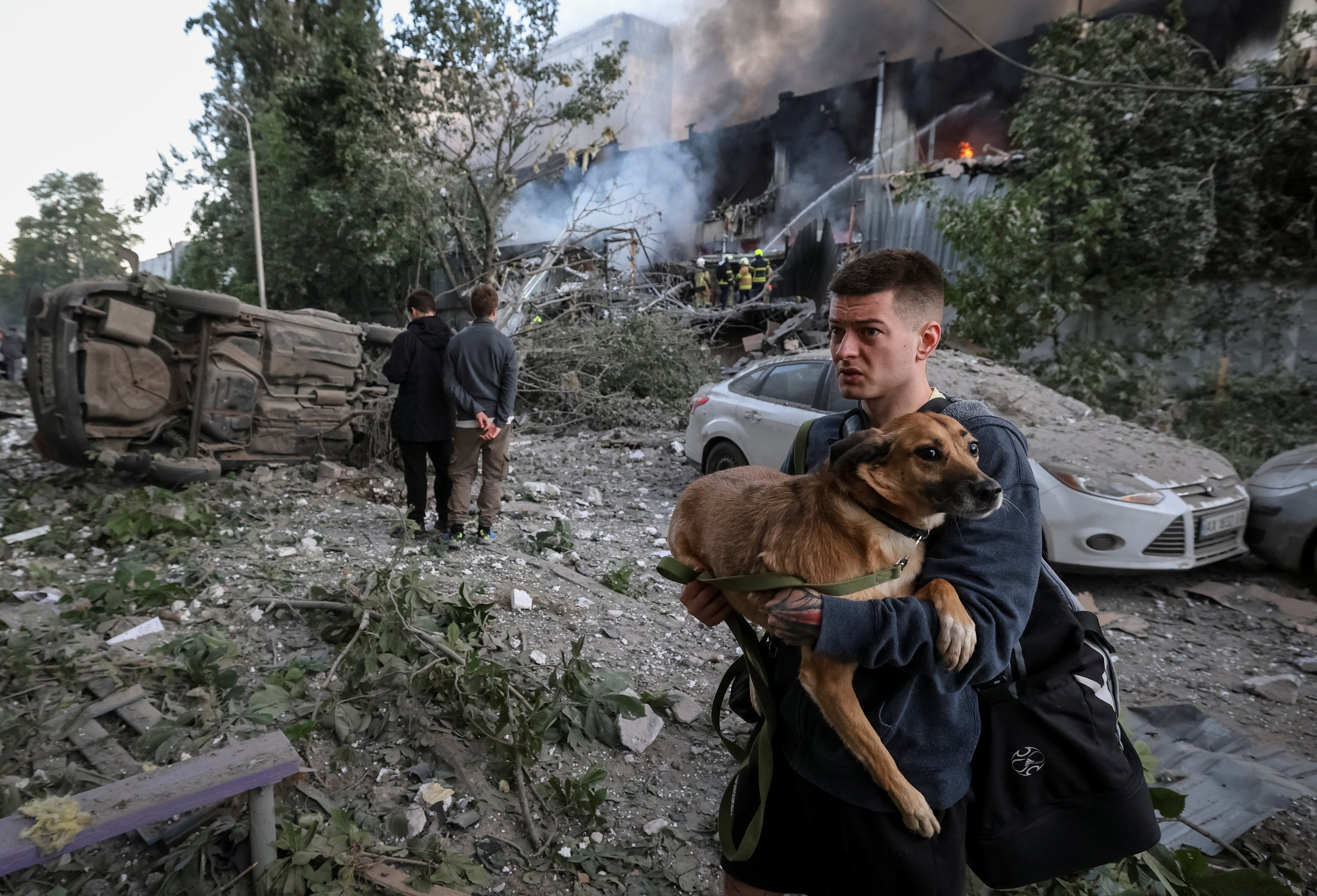A resident with a dog walks at a site of a Russian drone and missile strike, amid Russia's attack on Ukraine, in Kyiv, Ukraine June 2, 2026 (Reuters)