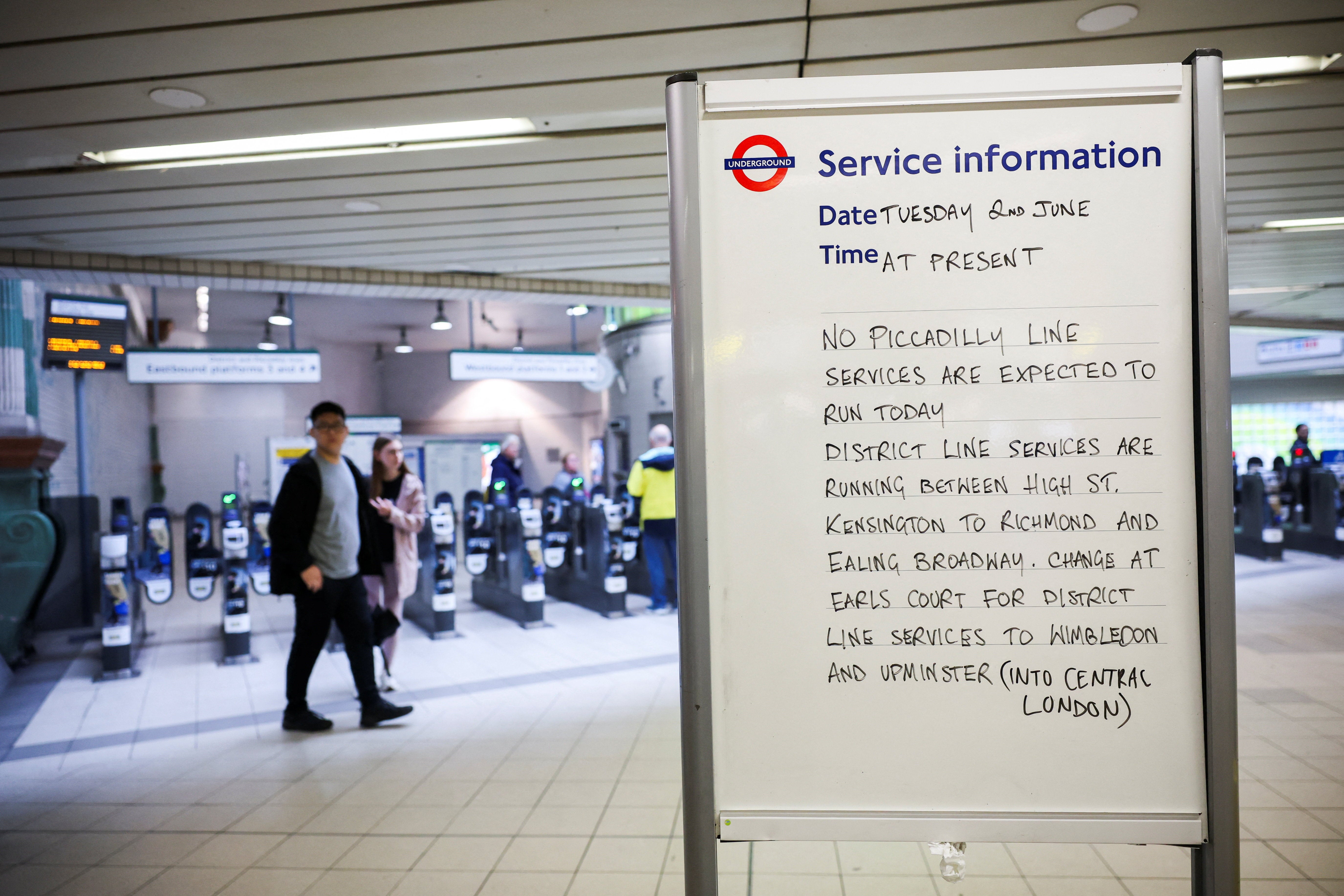A sign lists service disruption details at Hammersmith underground station (Reuters)