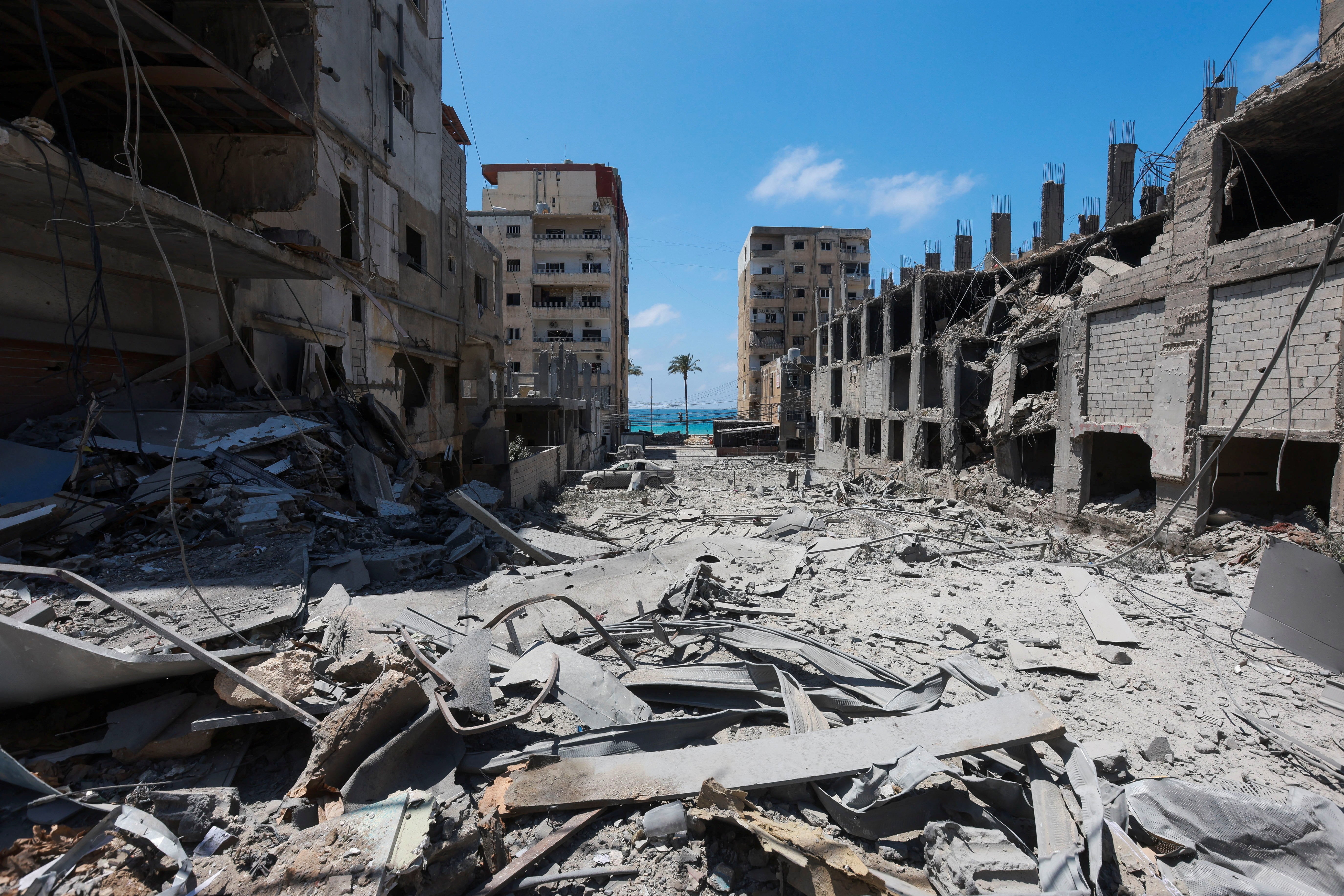 People inspect the damage in the aftermath of an Israeli strike in Tyre, Lebanon, on Tuesday (Reuters)