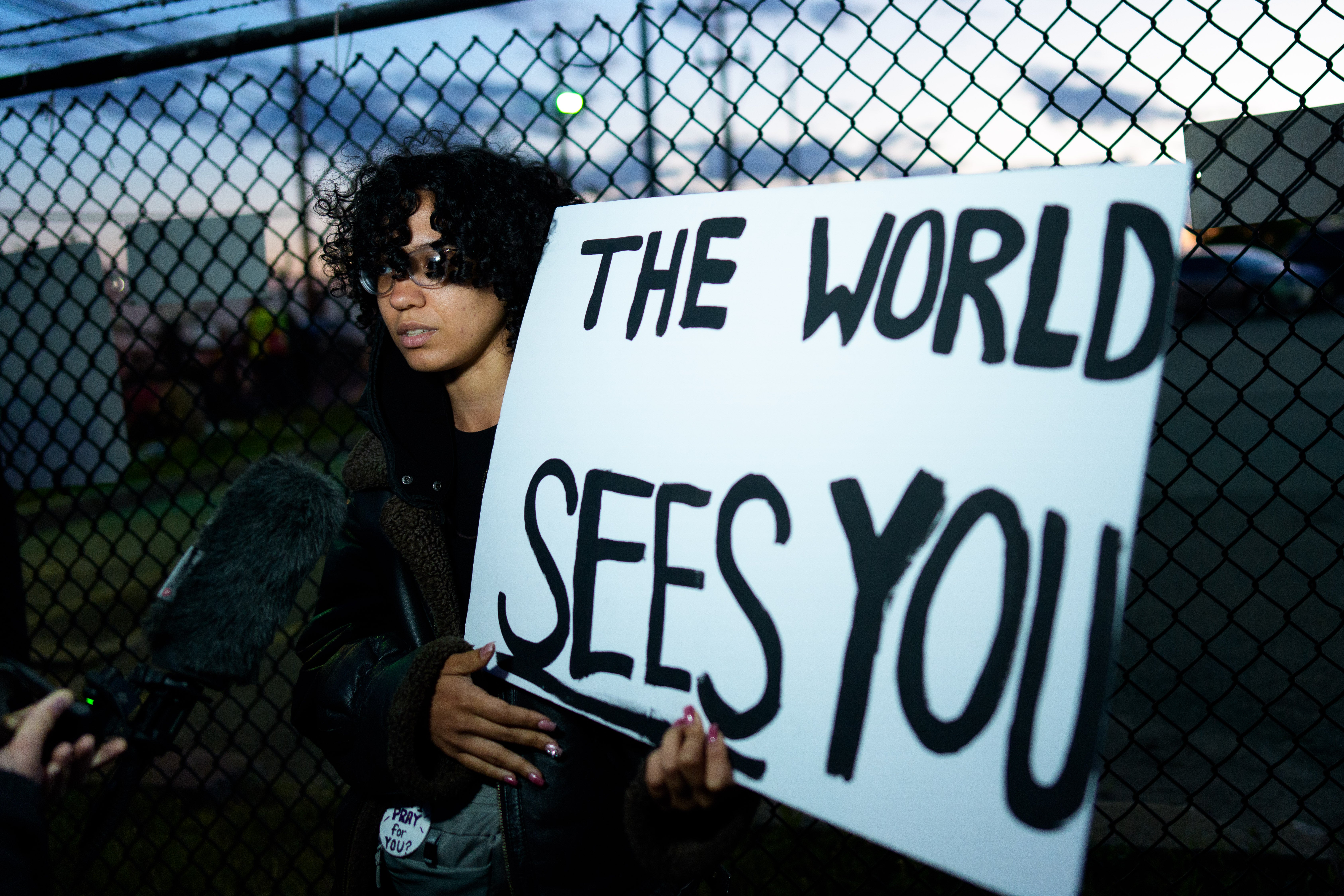 A person holds a sign outside the Delaney Hall Immigration Detention Center in Newark, where ICE is housing detained immigrants