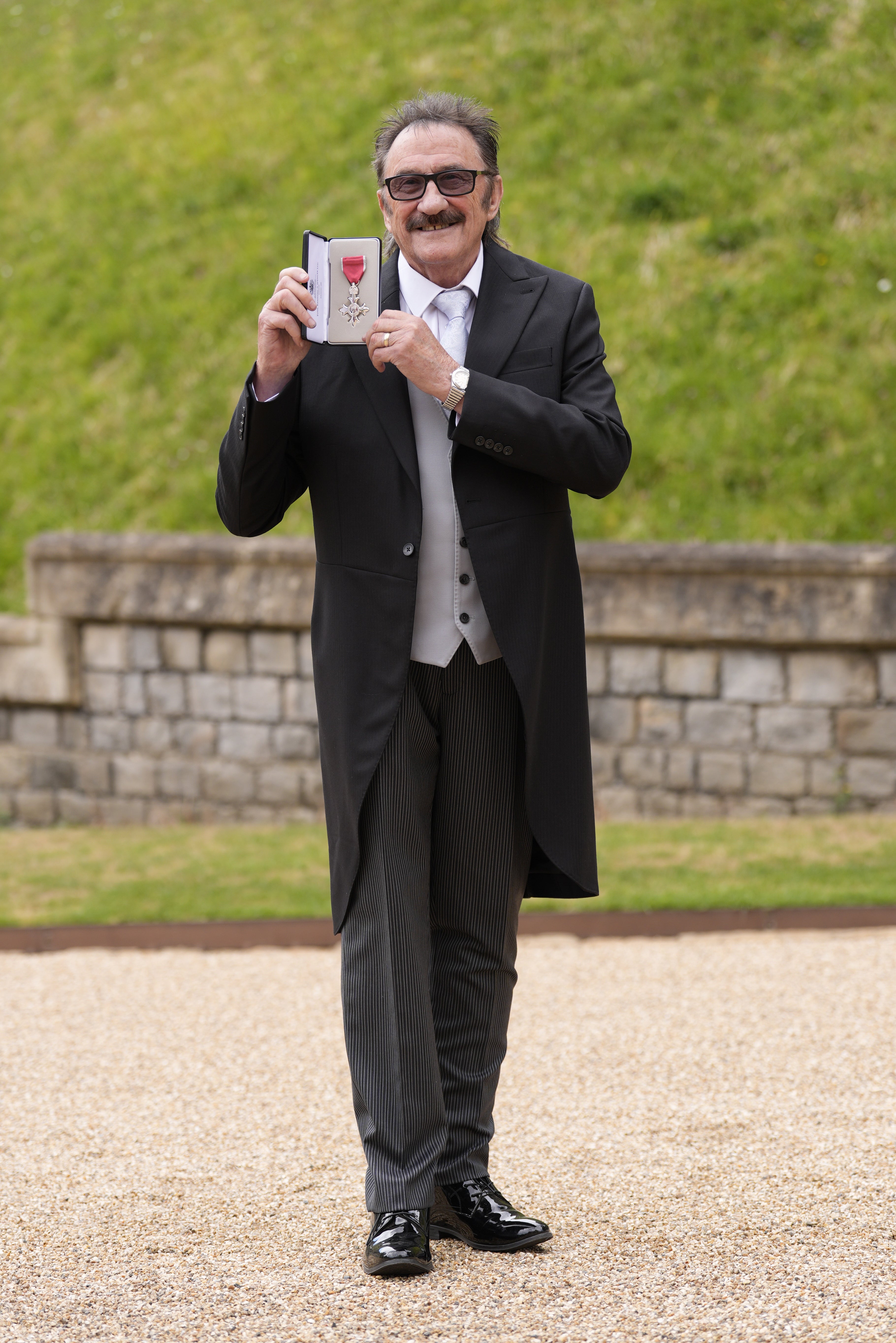 Paul Elliott after being made an MBE by the King at Windsor Castle (Andrew Matthews/PA)